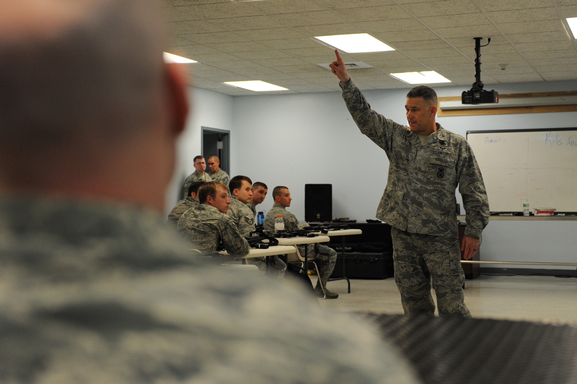 Col. Randall Richert, Air Mobility Command chief of security forces and directorate of installations and mission support, lectures on the importance of high training standards during a training session at Scott Air Force Base, Ill. on April 7, 2014. Security forces members from 16 bases and agencies came to Scott for a one-of-a-kind, week-long training session. (U.S. Air Force photo/Senior Airman Sarah Hall-Kirchner)