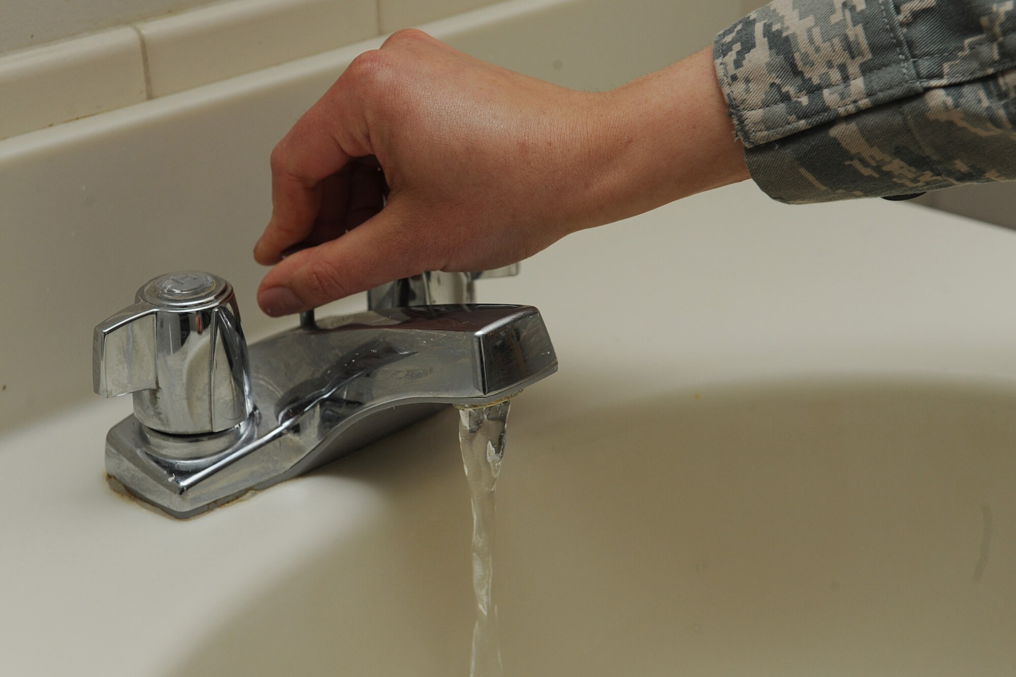 Staff Sgt. Erika Wenzel checks a sink to make sure it’s working properly during a room inspection at Scott Air Force Base, Ill., March 31, 2014.  If something is broken, Wenzel coordinates with the correct offices to fix the problem.  Wenzel is responsible for taking care of more than 380 Airmen throughout three dormitories: Belleville, Shiloh and Mascoutah.  Wenzel is a 375th Civil Engineering Squadron Airman dormitory leader.  (U.S. Air Force photo by Staff Sgt. Maria Bowman)