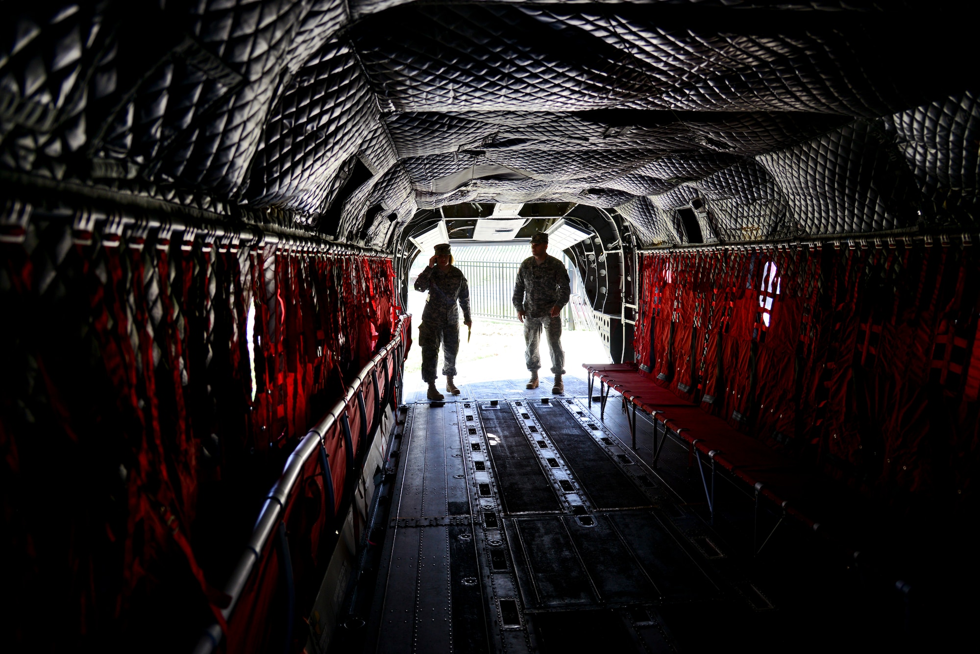 U.S. Army Soldiers enter the back of a CH-47 Chinook helicopter after a ribbon-cutting ceremony to celebrate the return of the newly-refurbished aircraft to the U.S. Army Transportation Museum on Fort Eustis, Va., April 11, 2014. After nearly a year of restorations, the 55-year-old helicopter was displayed at the museum. (U.S. Air Force photo by Senior Airman Aubrey White/Released)
