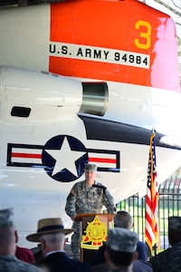 U.S. Army Col. John P. Sullivan, U.S. Army Transportation School, chief of transportation and commandant, speaks to audience members at a historic CH-47 Chinook helicopter return ceremony at the U.S. Army Transportation Museum at Fort Eustis, Va., April 11, 2014. Sullivan spoke briefly of the helicopter’s history and his pride to have the aircraft on display at Fort Eustis. (U.S. Air Force photo by Senior Airman Aubrey White/Released) 