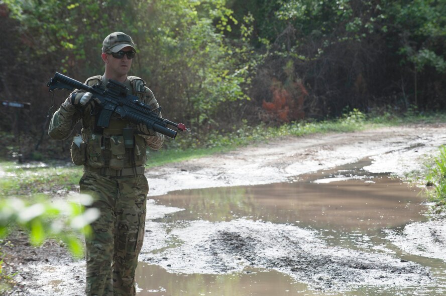 U.S. Air Force Tech. Sgt. Tom Gillespie, 347th Operations Support Squadron HH-60 aerial gunner, searches for enemy ‘survivors’ during a Combat Survival Training exercise at Moody Air Force Base, Ga., April 8, 2014. Gillespie lead the opposing forces in searching for aircrew members participating in the exercise. (U.S. Air Force photo by Airman Dillian Bamman/Released)