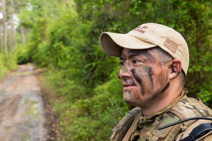 U.S. Air Force Tech. Sgt. Vincent Hnat, 41st Rescue Squadron special missions aviator, discusses his navigation plan at Moody Air Force Base, Ga., April 8, 2014. Airmen divided into two teams of three and had to work together to move stealthily to predetermined locations. (U.S. Air Force photo by Airman 1st Class Ryan Callaghan/Released)