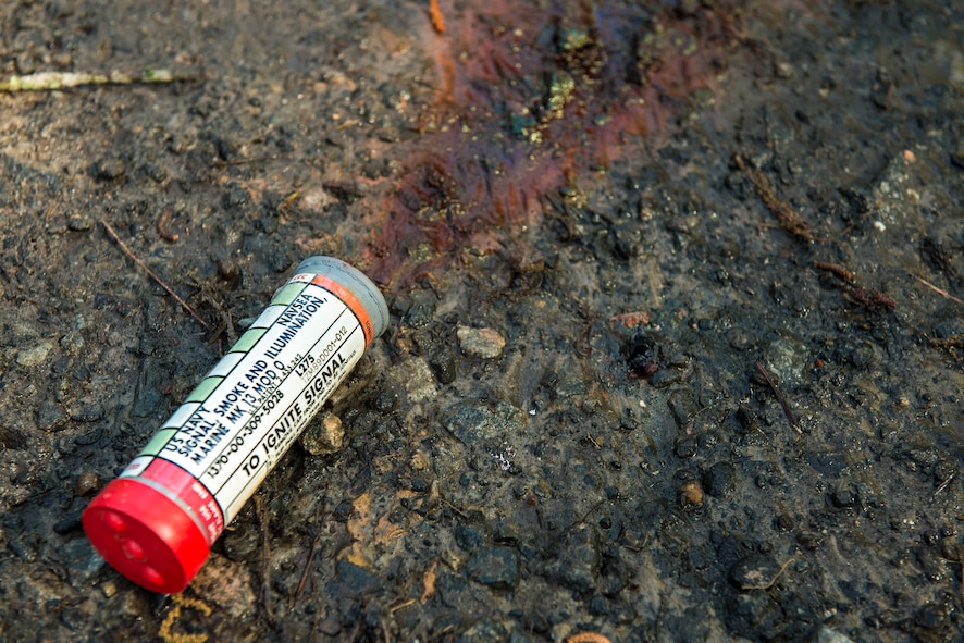 A used smoke signal lies on the ground at Moody Air Force Base, Ga., April 8, 2014. Aircrew members are issued a survival pack containing smoke signals, compasses and mirrors for use in the event they are involved in an aircraft accident and become stranded. (U.S. Air Force photo by Airman 1st Class Ryan Callaghan/Released)