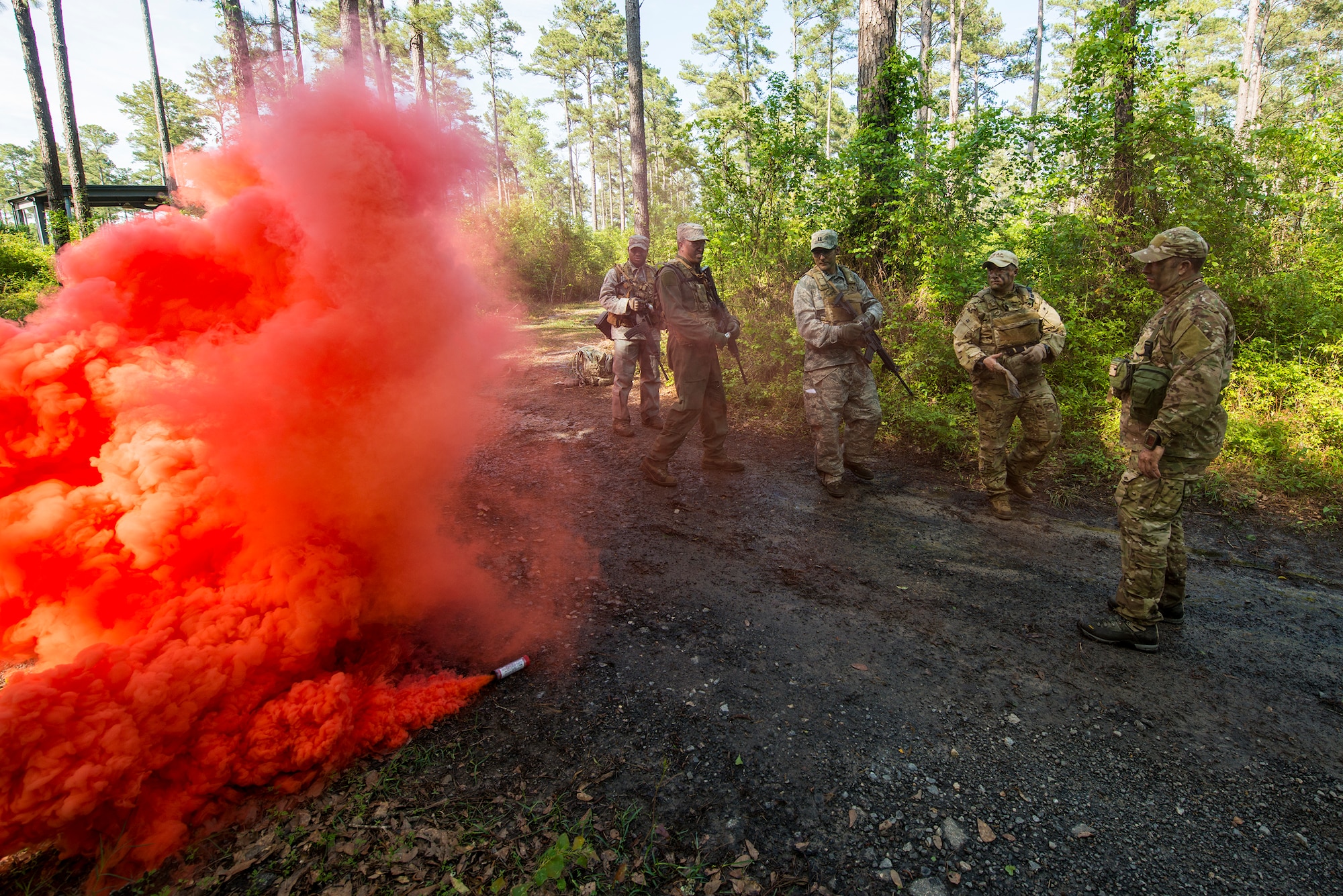 Airmen participating in combat survival training deploy smoke signals at Moody Air Force Base, Ga., April 8, 2014. Combat survival training teaches Airmen evade and navigate in hostile territories, operate aircrew life support equipment, maintain contact with friendly forces and ultimately, get rescued. (U.S. Air Force photo by Airman 1st Class Ryan Callaghan/Released)