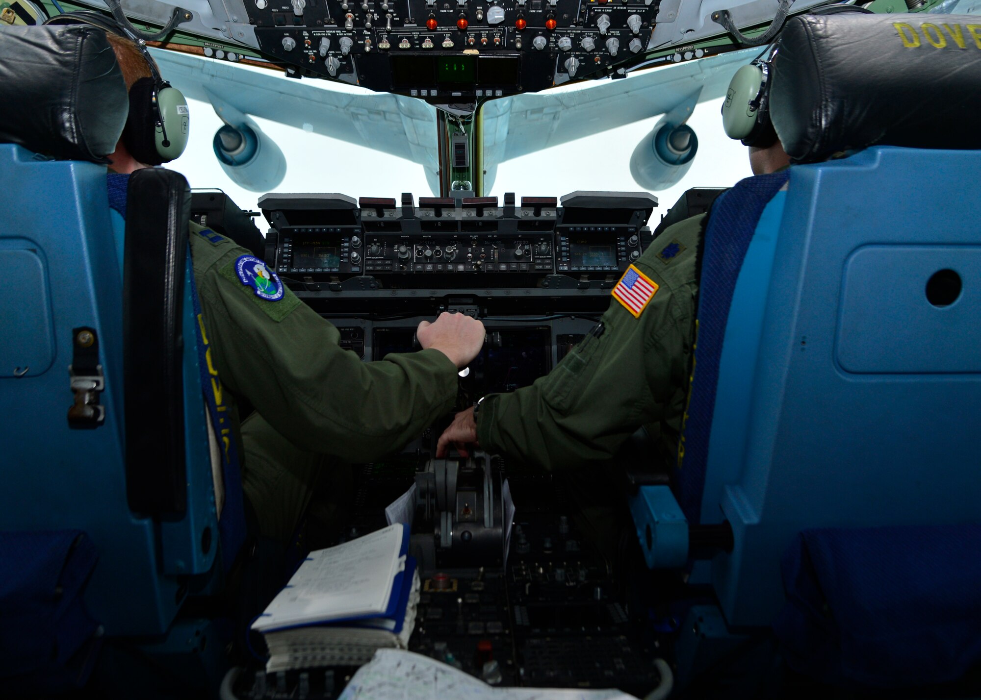 Capt. Matthew Cellemme, 436th Operations Support Squadron system director of operations, left, and Lt. Col. Steven Sylvester, 3d Airlift Squadron director of operations, maneuver a C-17 Globemaster III behind a KC-10 for air refueling operations April 7, 2014, over Dover Air Force Base, Del. The air refueling operations were part of a seven day long East Coast Combat Operations Exercise. (U.S. Air Force photo/Airman 1st Class William Johnson)