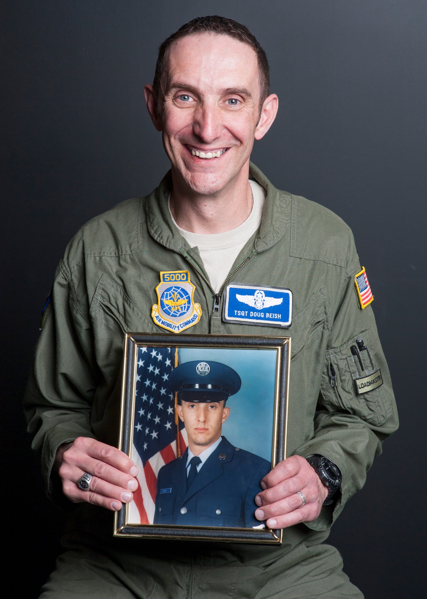 Tech. Sgt. Doug Beish, 436th Operations Support Squadron C-5M Super Galaxy loadmaster trainer, holds his basic military training photo April 11, 2014, on Dover Air Force Base, Del. Beish graduated BMT in 1994 and will retire after 20 years to become a train conductor. (U.S. Air Force photo/ Senior Airman Jared Duhon)