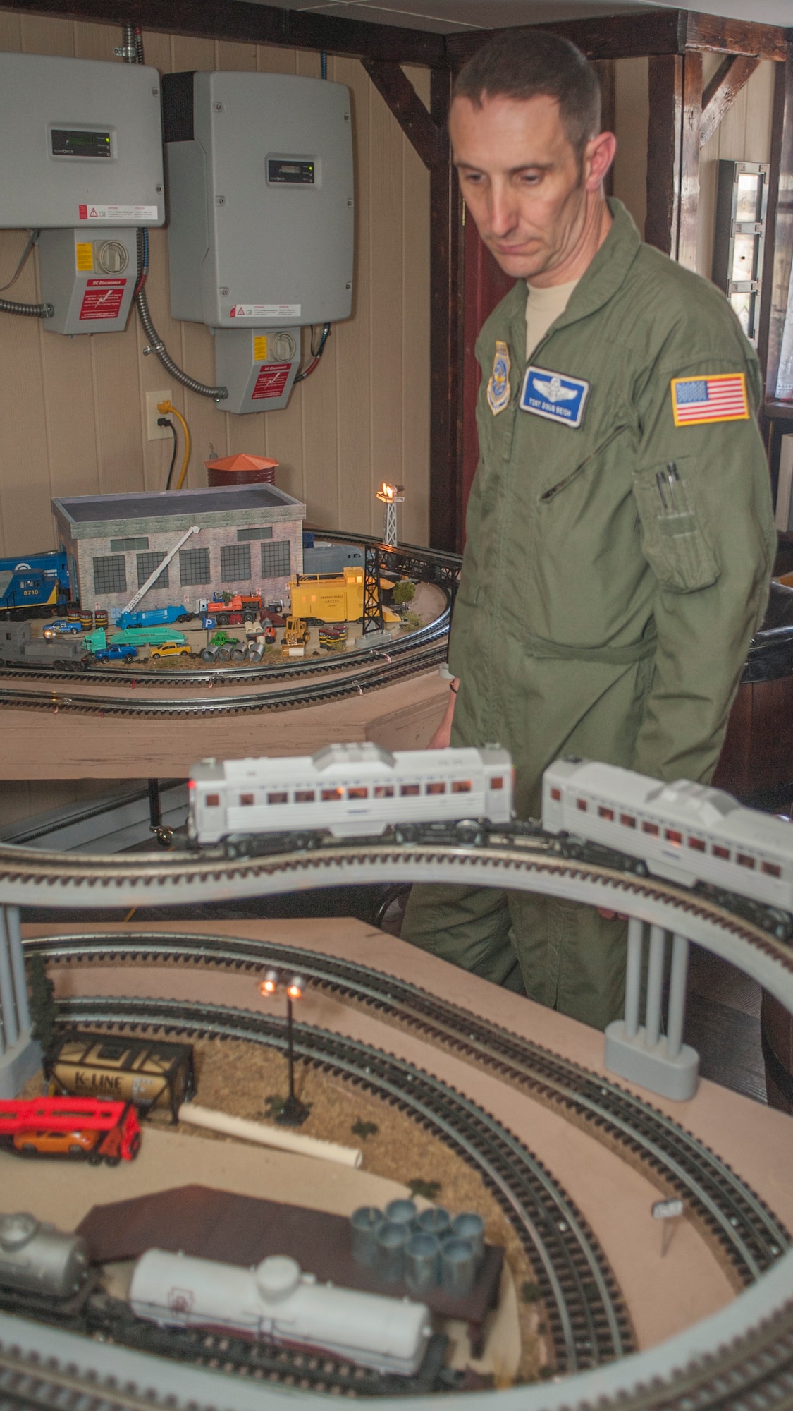Tech. Sgt. Doug Beish, 436th Operations Support Squadron C-5M Super Galaxy loadmaster trainer, monitors his model trains as they speed past him April 9, 2014, at his parents’ home in Dover, Del. Beish will begin work as a train conductor after he retires from his job as an Air Force C-5M Super Galaxy loadmaster. (U.S. Air Force photo/Senior Airman Jared Duhon)