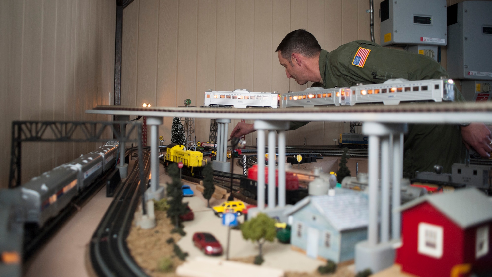 Tech. Sgt. Doug Beish, 436th Operations Support Squadron C-5M Super Galaxy loadmaster trainer, adjusts a model train assessor while trains rush by April 9, 2014, at his parents’ home in Dover, Del. Beish joined the Air Force in 1994 and has been able to work with the other military branches and serve on an international scale. (U.S. Air Force photo/Senior Airman Jared Duhon) 