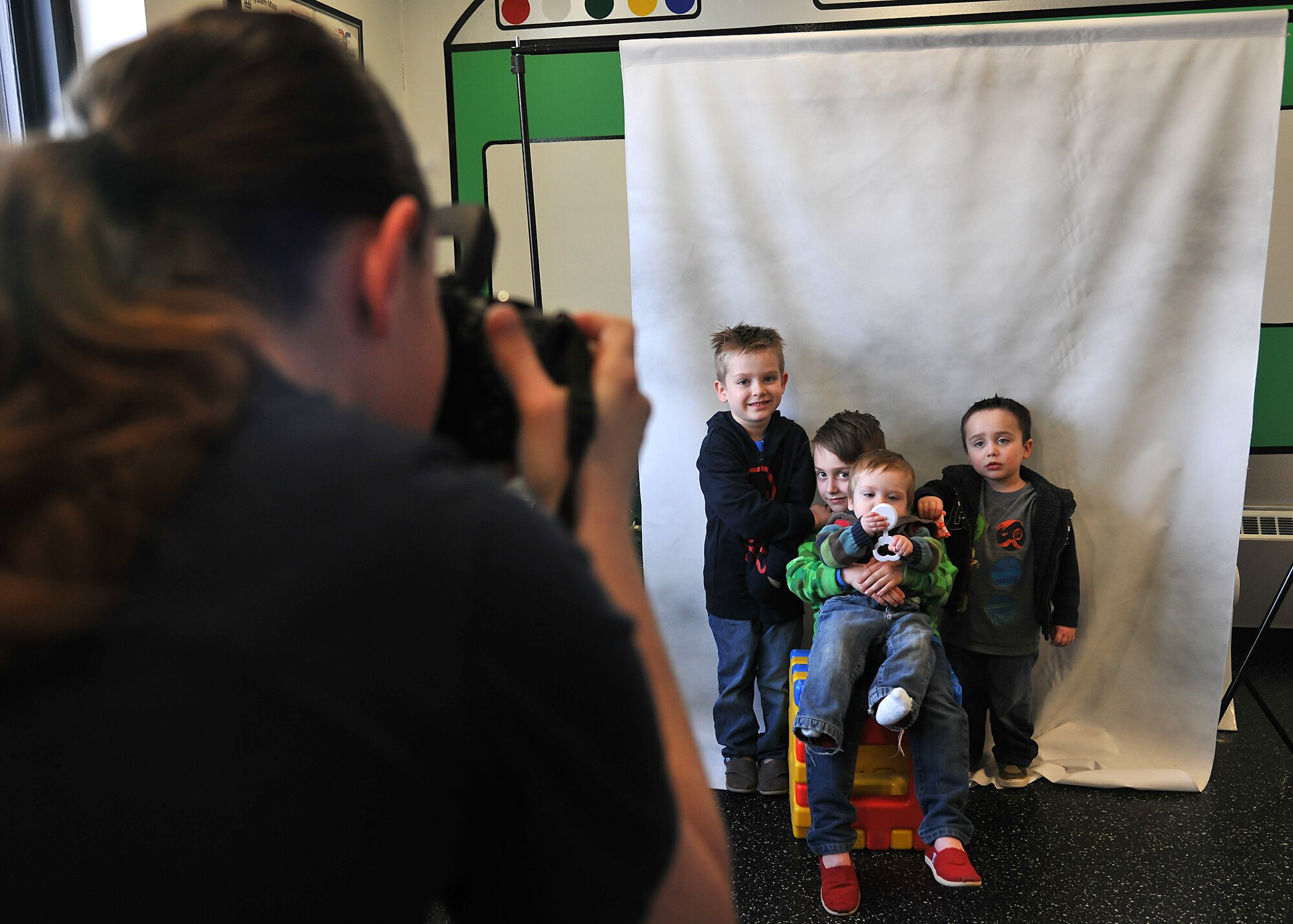 Tech. Sgt. Kimberley Rivera, 319th Medical Operations Squadron mental health NCOIC, takes a photo of the children from the Mendez family during the Beautiful Child Photo Shoot and Activity Fair on April 9, 2014 at Liberty Square on Grand Forks Air Base, N.D. The goal of the was to give families a chance to get together to celebrate Month of the Military Child as well as Child Abuse Prevention Month, which are observed in April. (U.S. Air Force photo/Senior Airman Xavier Navarro)