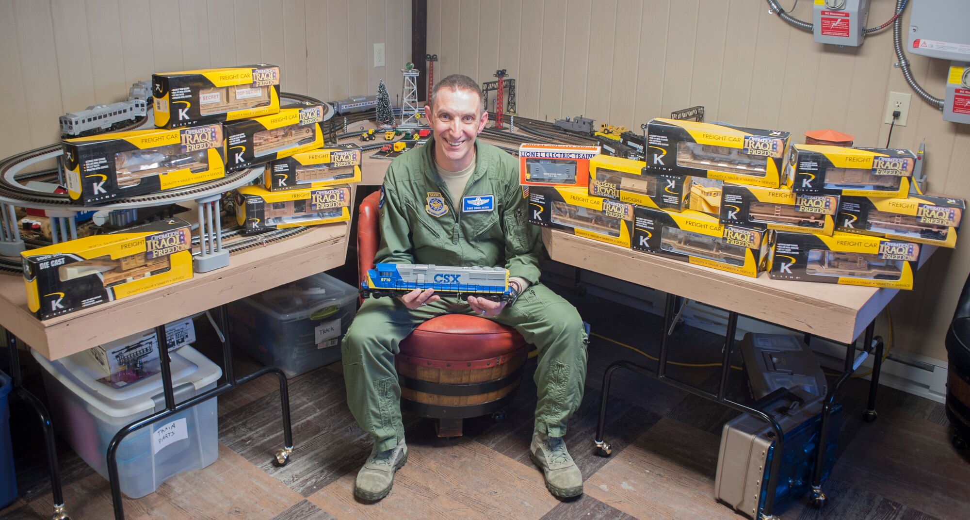 Tech. Sgt. Doug Beish, 436th Operations Support Squadron C-5M Super Galaxy loadmaster trainer, sits in the middle of his first military model train set April 9, 2014, at his parents’ home in Dover, Del. Beish’s love for trains comes from his father, who is a welder that worked for a  train car manufacturer. (U.S. Air Force photo/Senior Airman Jared Duhon)  