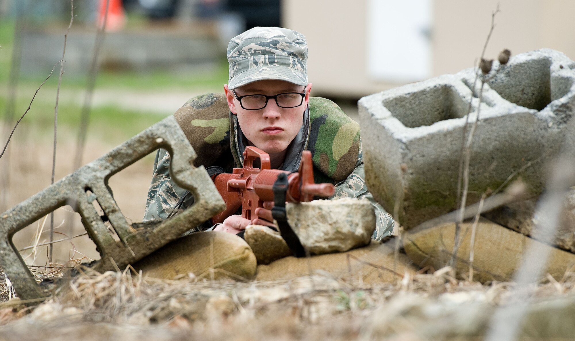 Airman 1st Class Michael Woodward, a 436th Civil Engineer Squadron engineering assistant journeyman, lays in the M16 prone firing position April 8, 2014, at the deployment training area on Dover Air Force Base, Del. Woodward went through three days of training honing his skills as a Prime Base Engineer Emergency Forces team member. (U.S. Air Force photo/Roland Balik)