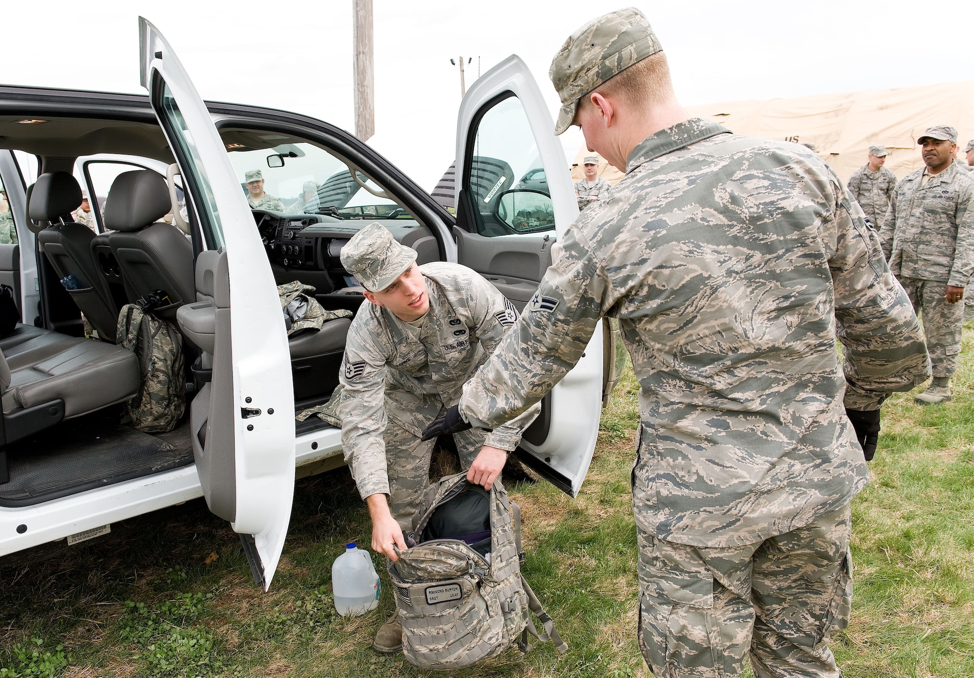 Staff Sgt. Thomas Lowe, left, a structural craftsman, opens a backpack for Airman 1st Class Kaleb Ponder, right, a structural apprentice, both from the 436th Civil Engineer Squadron during a simulated vehicle search April 8, 2014, at the deployment training area on Dover Air Force Base, Del. Prime Base Engineer Emergency Forces personnel from the 436th CES went through three days of training to prepare squadron members for world-wide missions. (U.S. Air Force photo/Roland Balik)