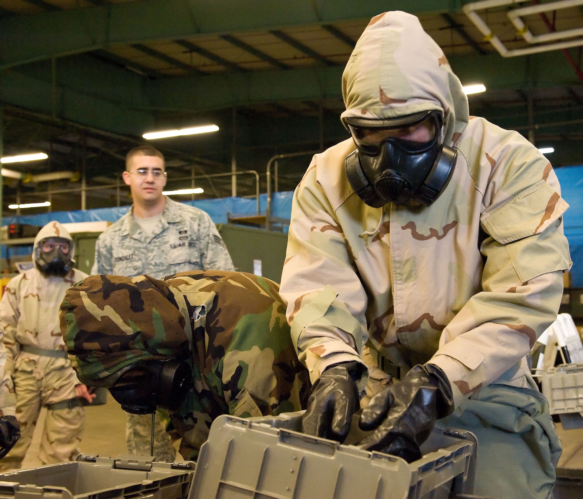 Team Dover members simulate decontamination procedures during a Chemical Biological Radiological and Nuclear survival skills training class April 7, 2014, at Dover Air Force Base, Del. The 436th Civil Engineer Squadron Emergency Management and Training Section provided CBRNE training to prepare personnel for world-wide missions. (U.S. Air Force photo/Roland Balik)