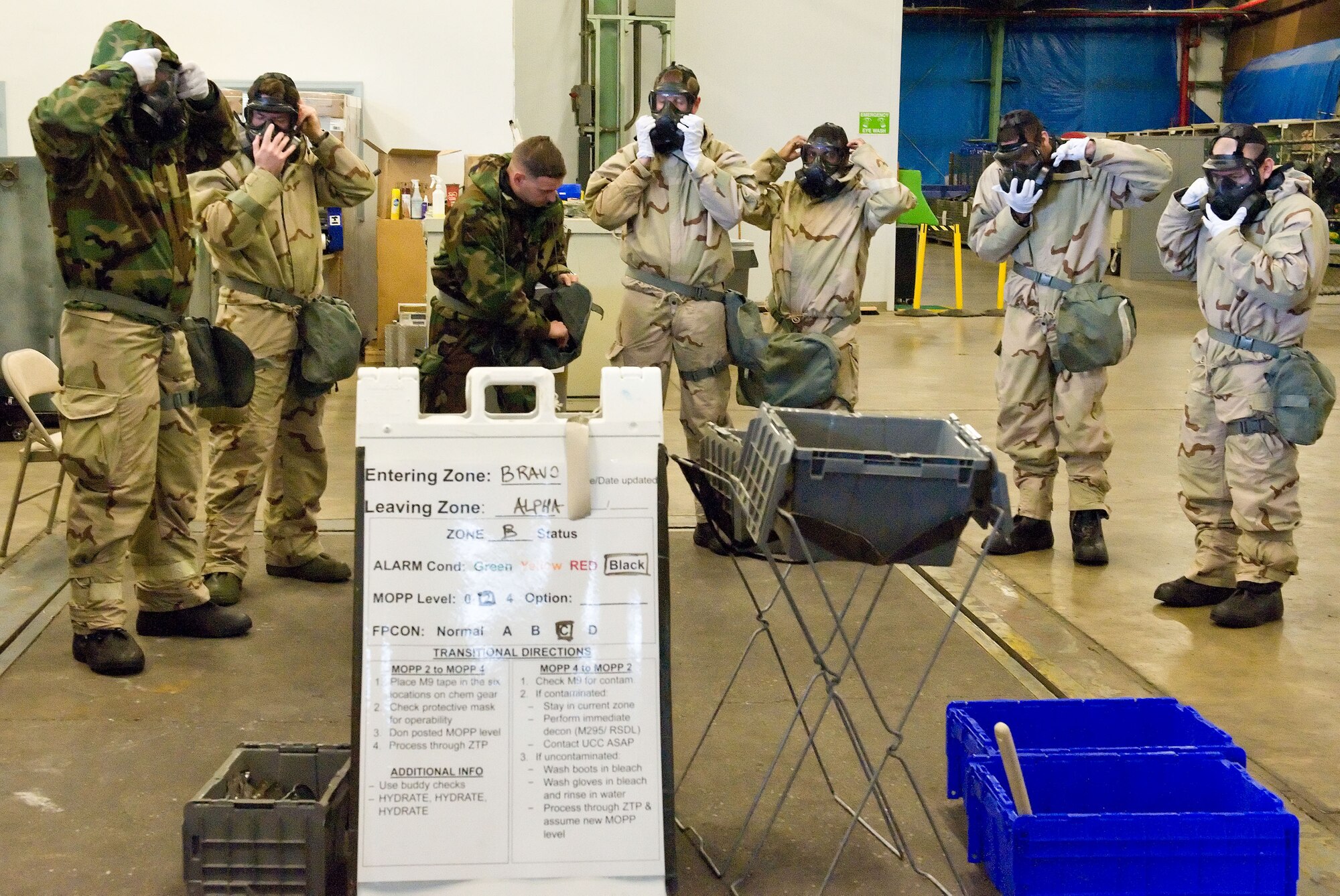 Team Dover personnel don their chemical masks during a Chemical Biological Radiological and Nuclear survival skills training class April 7, 2014, at Dover Air Force Base, Del. The 436th Civil Engineer Squadron Emergency Management and Training Section provided training to personnel over a three-day period. (U.S. Air Force photo/Roland Balik)