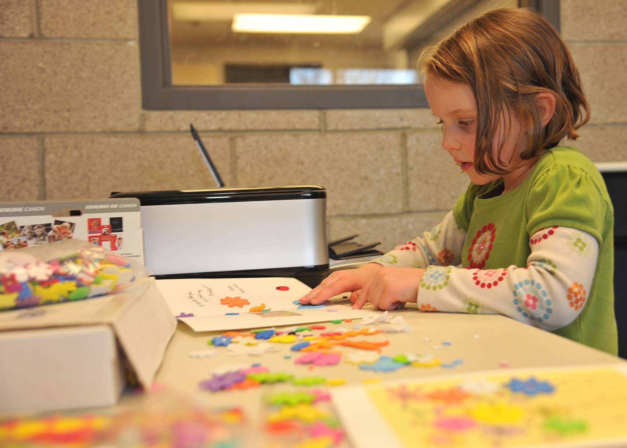 Kinley Hendericks, 5, makes a personalized card during the Beautiful Child Photo Shoot and Activity Fair on April 9, 2014 at Liberty Square on Grand Forks Air Force Base, N.D. The North Dakota State University youth development center provided activities for children to create cards for their parents who are deployed. (U.S. Air Force photo/Senior Airman Xavier Navarro)
