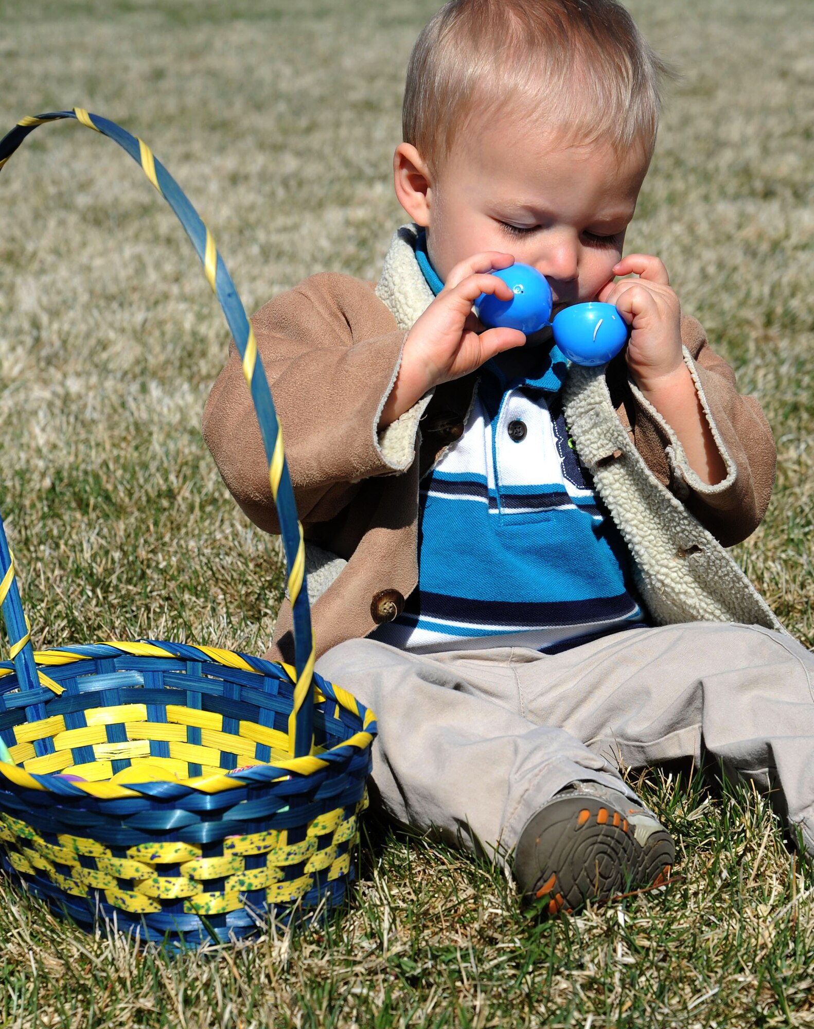 Children gathered Easter eggs scattered around the baseball field during an Easter egg hunt event at Fairchild Air Force Base, Wash., April 12, 2014. There were separate egg hunts designed for different age groups. The event was sponsored by the 92nd Force Support Squadron. (U.S. Air Force photo by Airman 1st Class Janelle Patiño/Released)