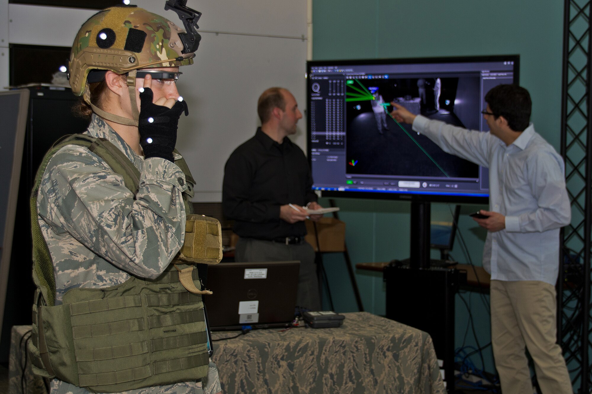 Left to right: 2Lt. Krystin Shanklin demonstrating the use of Google Glass
while Gregory Burnett, BATMAN Chief Engineer, and Andres Calvo, software
engineer and member of the BATMAN team, 711 Human Performance Wing, Air
Force Lab, review the computer screen. (Photo by Richard Eldridge, 711 HPW)
