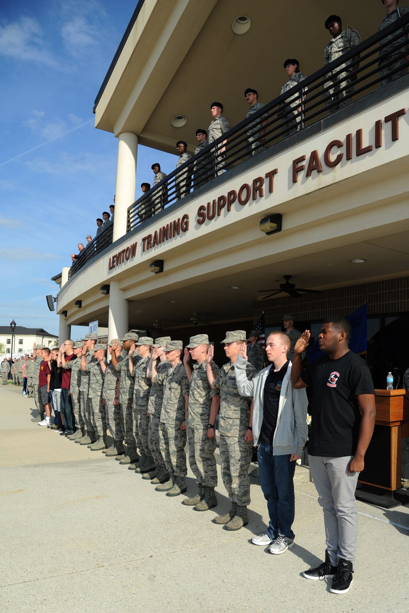 The 81st Training Group’s newest Airmen promotees repeat the oath of enlistment during a dragon recognition presentation April 11, 2014, behind the Levitow Training Support Facility, Keesler Air Force Base, Miss.  The ceremony reinforced their commitment as they take on new responsibilities with their promotion. The event also included the announcements of Airman of the Month and military training flight of the Month for March.  (U.S. Air Force photo by Kemberly Groue)