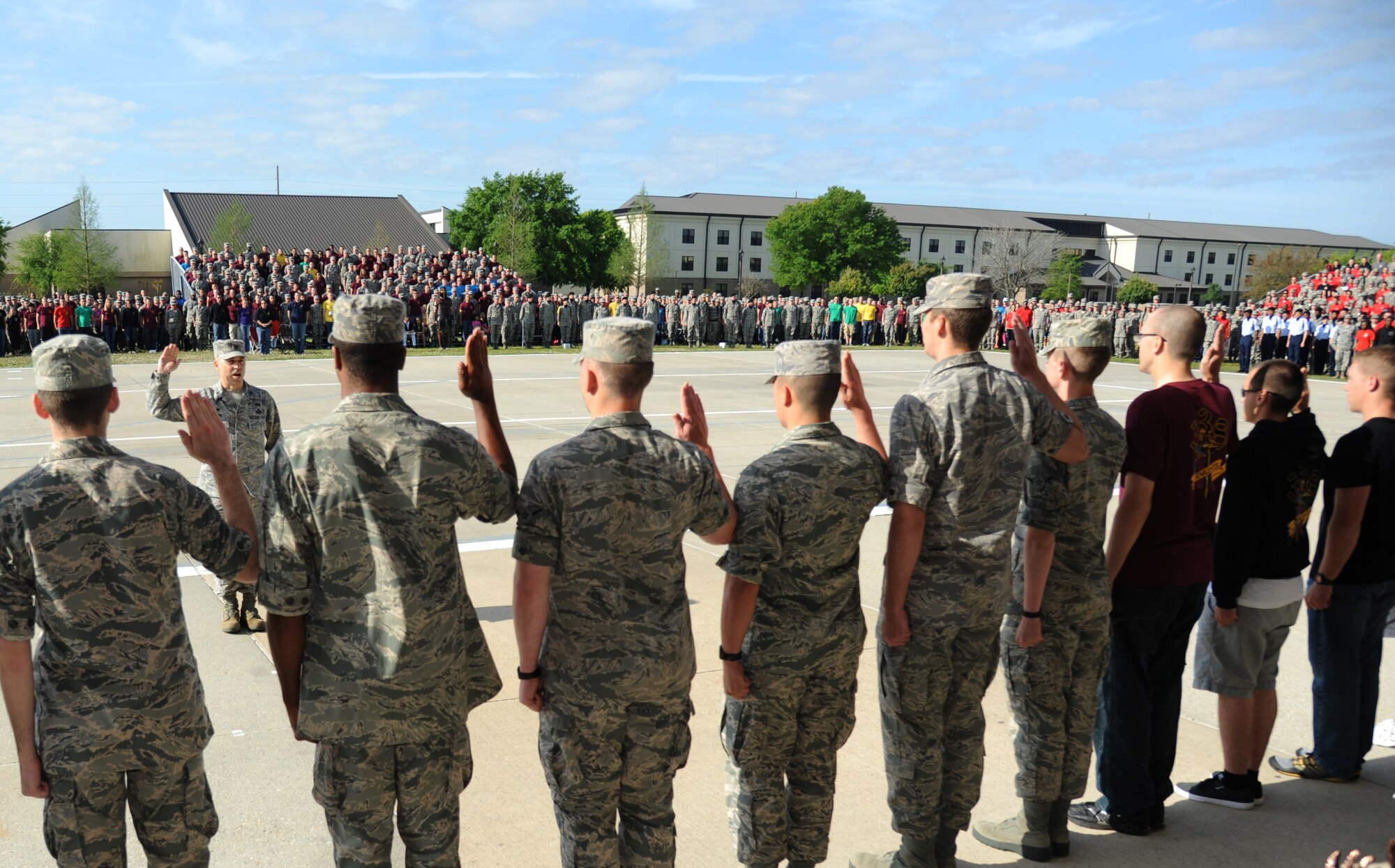 Col. George Tombe, 81st Training Group commander, administers the oath of enlistment to the Training Group’s newest Airmen promotees during a dragon recognition presentation April 11, 2014, behind the Levitow Training Support Facility, Keesler Air Force Base, Miss.  The ceremony reinforced their commitment as they take on new responsibilities with their promotion. The event also included the announcements of Airman of the Month and military training flight of the Month for March.  (U.S. Air Force photo by Kemberly Groue)