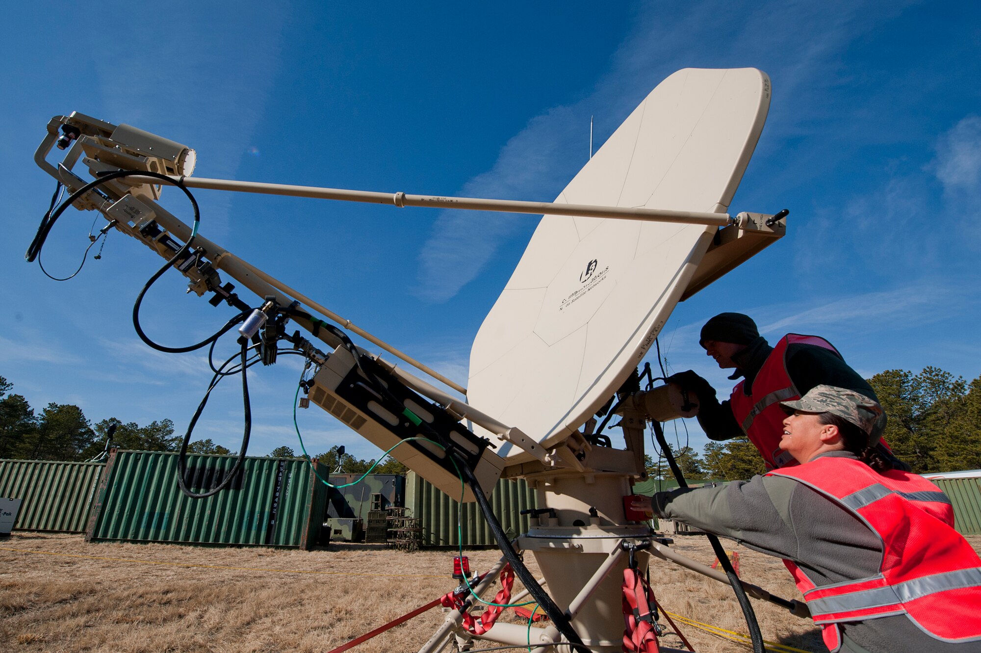Tech. Sgt. Isaura Medina, 514th Aeromedical Evacuation Squadron and Senior Airman Justin Walsh, 42nd Combat Communications Squadron, check a satellite communications system out in the field during Operation Global Medic, Joint Base McGuire-Dix-Lakehurst, N.J., March 1.  Global Medic is a joint field training exercise for theater aeromedical evacuation system and ground medical components designed to replicate all aspects of combat medical service support.  (U.S. Air Force photo by Christian Deluca)