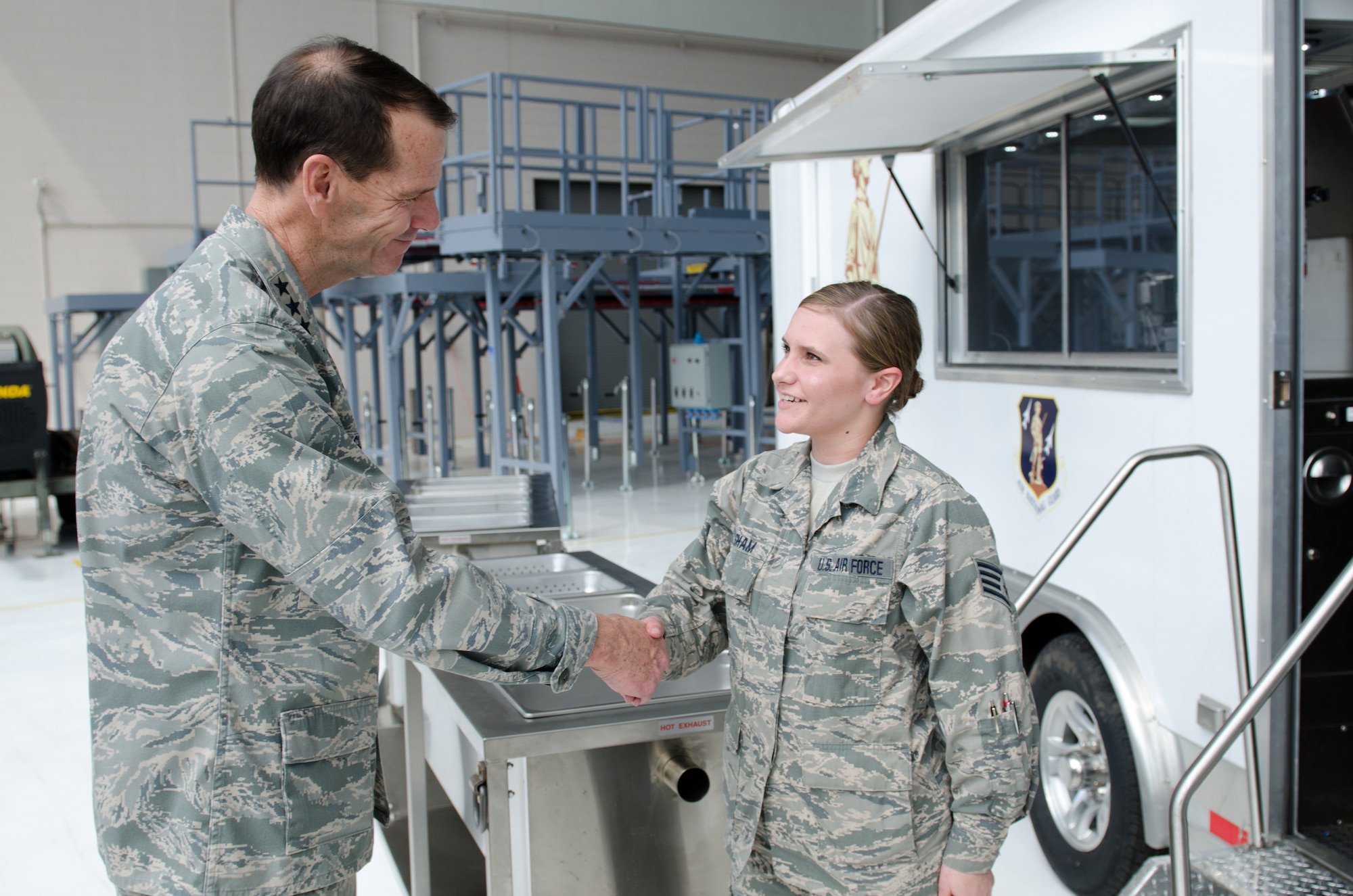 Lt. Gen. Stanley E. Clarke III, director of the Air National Guard, speaks with Staff Sgt. Shelby Basham of the 123rd Airlift Wing’s Fatality Search and Recovery Team during a tour of the Kentucky Air National Guard Base in Louisville, Ky., April 11, 2014. Clarke visited with Airmen from across the wing and examined mission capabilities ranging from contingency response to special tactics. (U.S. Air National Guard photo by Airman 1st Class Joshua Horton)