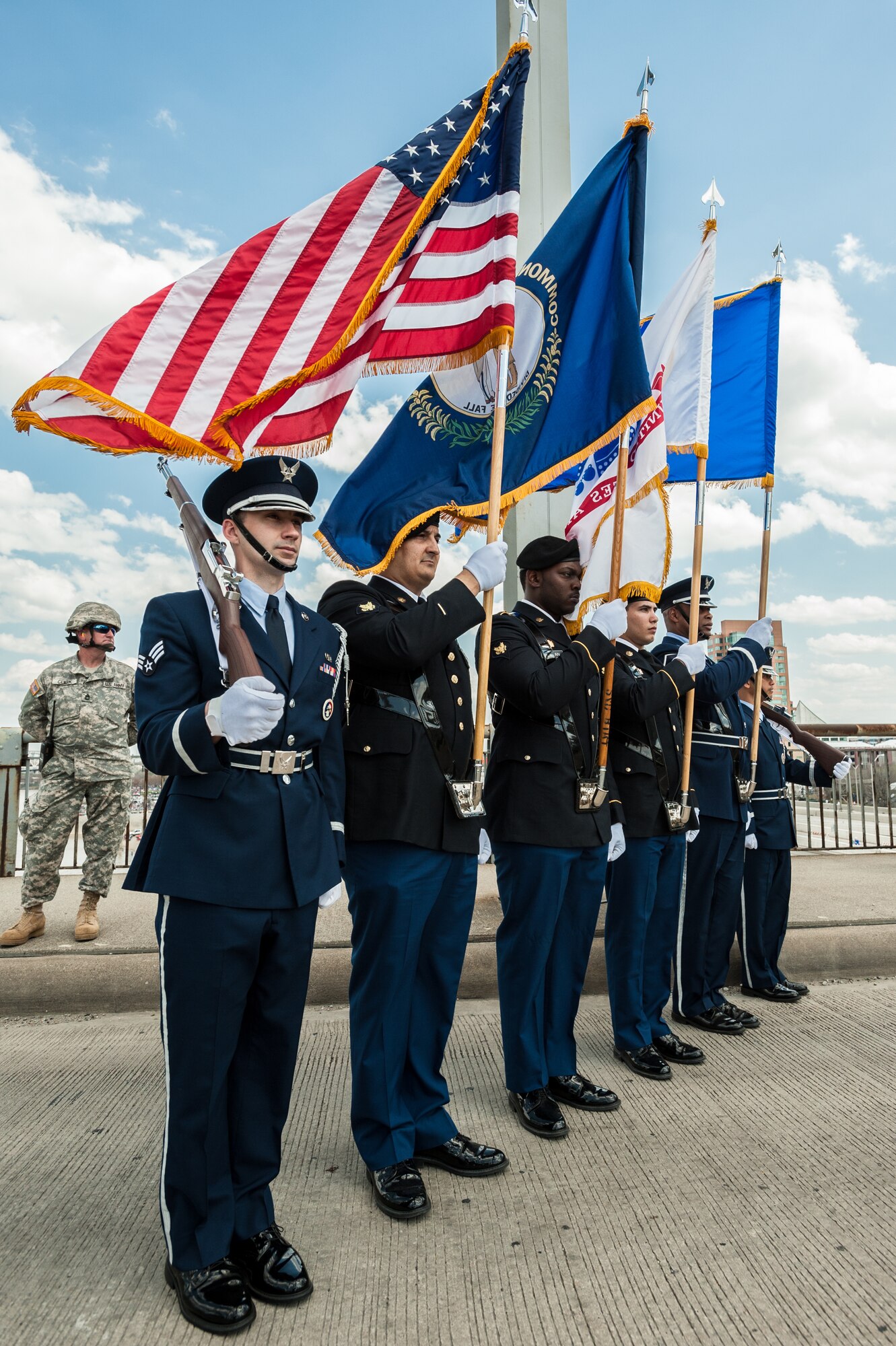 A joint Color Guard, comprised of members from the Kentucky Army and Air National Guard, present the colors on the 2nd Street Bridge in Louisville, Ky., April 12, 2014, to begin the Thunder Over Louisville air show. The show drew more than 650,000 spectators this year. (U.S. Air National Guard photo by Maj. Dale Greer)