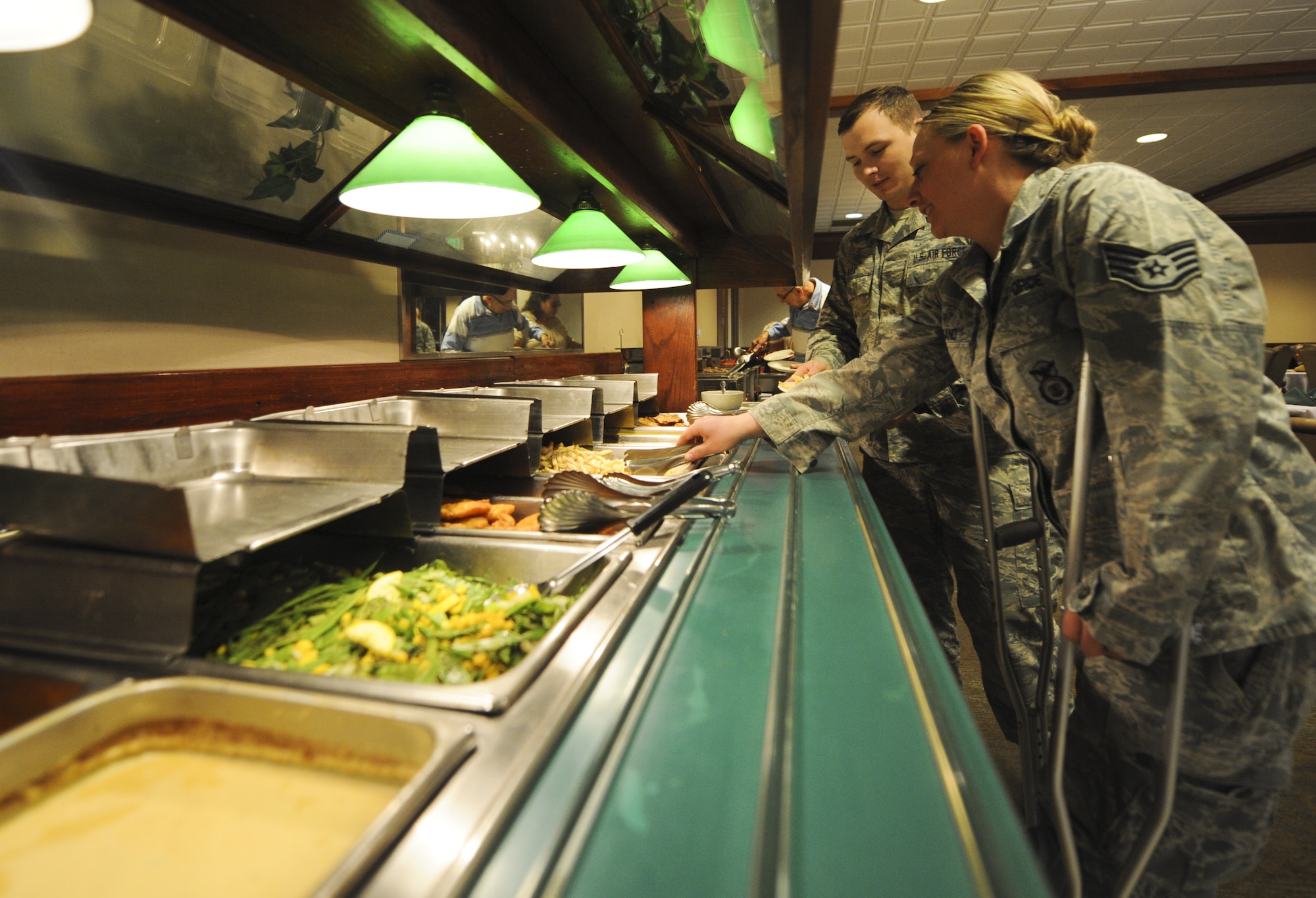 PETERSON AIR FORCE BASE, Colo. – Two 21st Security Forces Squadron members make their way through the lunch buffet at the Peterson Club here April 1. The lunch was prepared by a whole new team of chefs at the club. (U.S. Air Force photo/Staff Sgt. Jacob Morgan)
