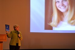Mary Lauterbach holds up the Inspector General’s report about her daughter's sexual assault during her speech to members of Joint Base Charleston during a Sexual Assault Awareness Month event April 11, 2014, at the Air Base Theater on JB Charleston, S.C. Lauterbach’s daughter, U.S. Marine Lance Cpl. Maria Lauterbach, was sexually assaulted and murdered while on active duty in 2007. (U.S. Air Force photo/Staff Sgt. Renae Pittman)