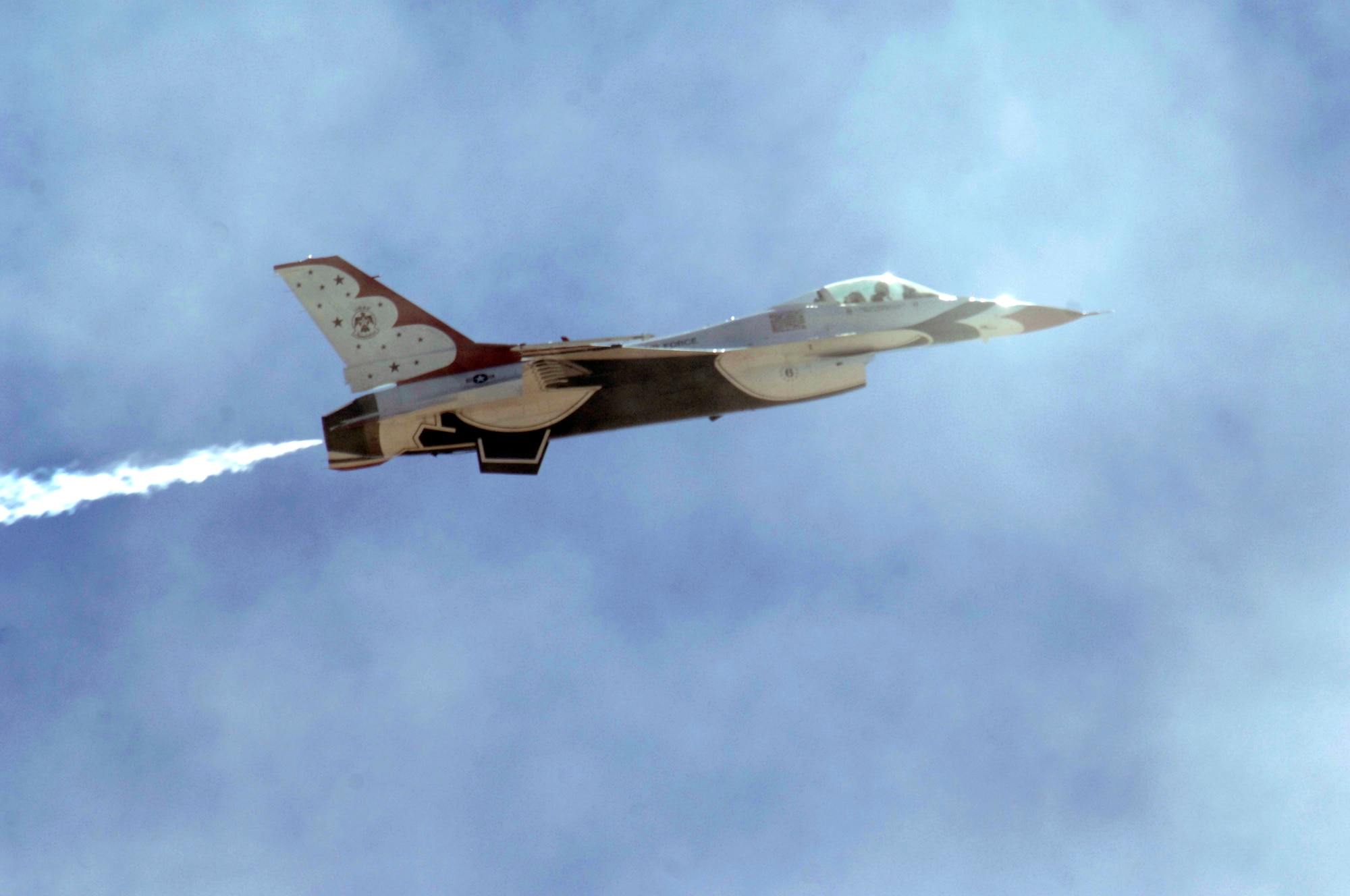 A U.S. Air Force Thunderbird performs a fly-by during the Thunder and Lightning over Arizona event at Davis-Monthan Air Force Base, Ariz., April 13, 2014. The base opened its doors for the free event to showcase military air power and express appreciation for the local community's continuous support of D-M's missions. (U.S. Air Force Photo by Airman 1st Class Chris Massey/Released)