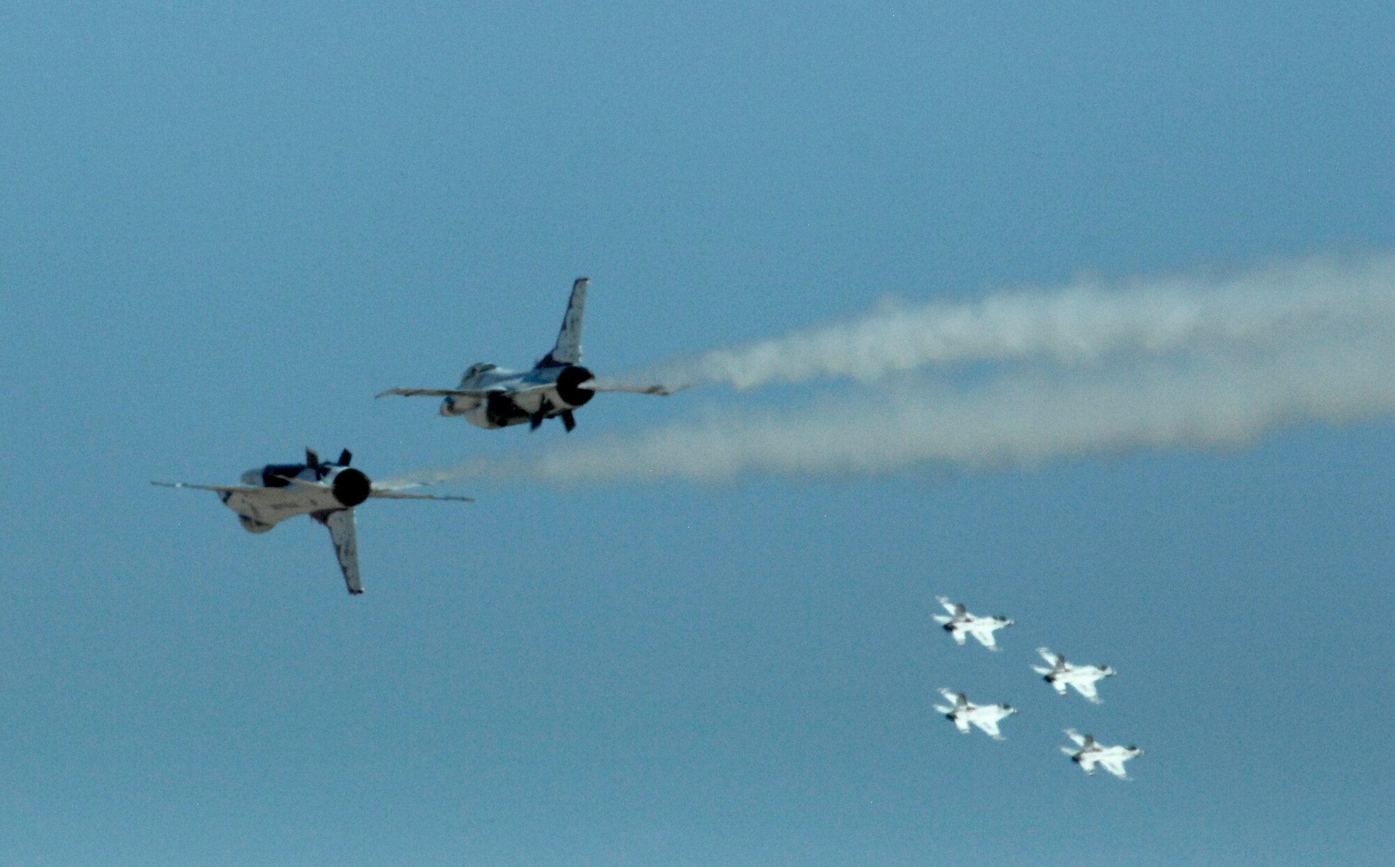 Two U.S. Air Force Thunderbirds fly close behind four others during the Thunder and Lightning over Arizona event at Davis-Monthan Air Force Base, Ariz., April 13, 2014. The two-day event featured 14 different aerial demonstrations and had more than 300,000 military and civilian attendees. (U.S. Air Force Photo by Airman 1st Class Chris Massey/Released)