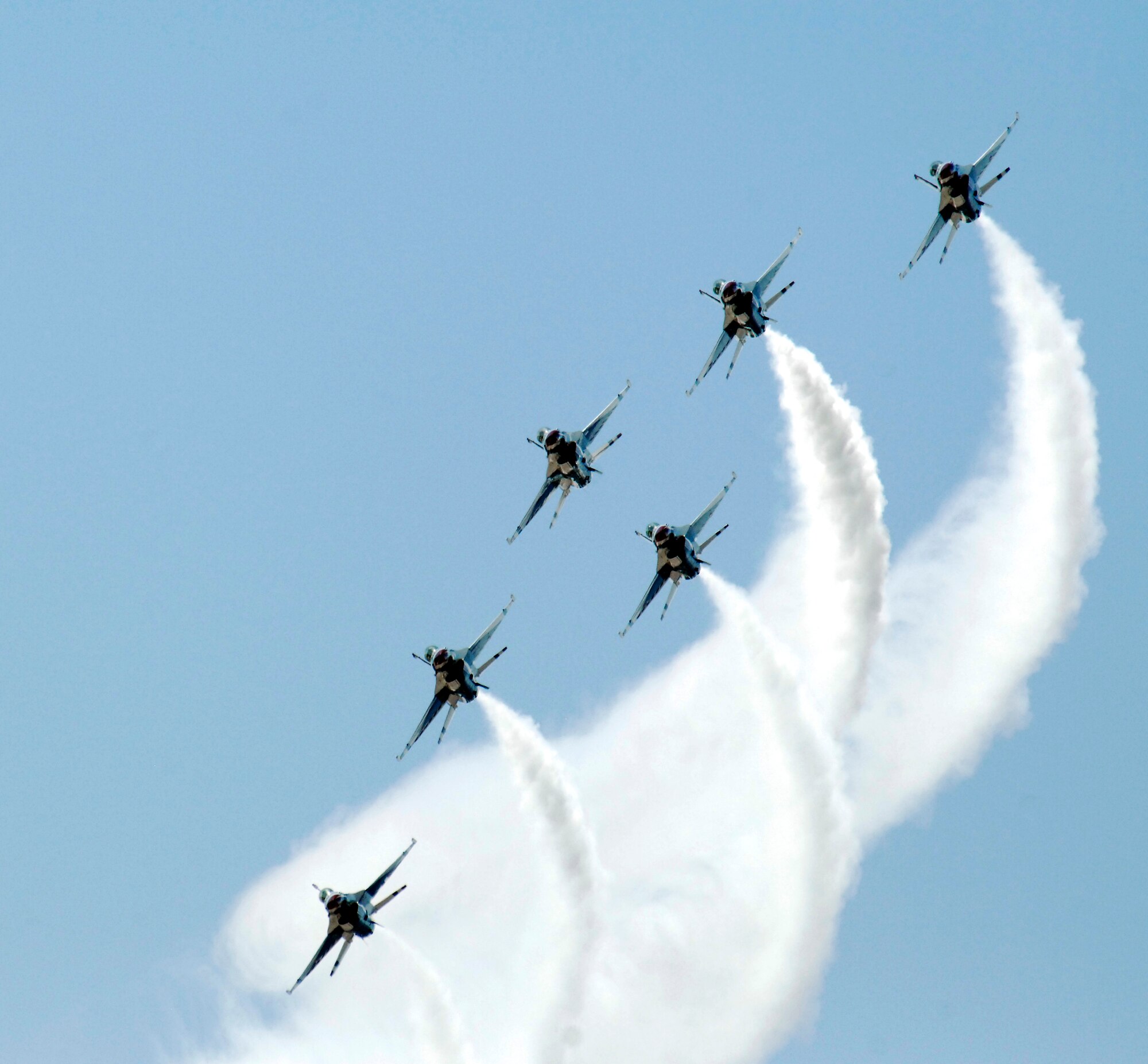 U.S. Air Force Thunderbirds Air Demonstration Squadron performs a smoke-streamed fly by during the Thunder and Lightning over Arizona event at Davis-Monthan Air Force Base, Ariz., April 13, 2014. The "Ambassadors in Blue" have been performing aerial demonstrations for more than 60 years. (U.S. Air Force Photo by Airman 1st Class Chris Massey/Released)