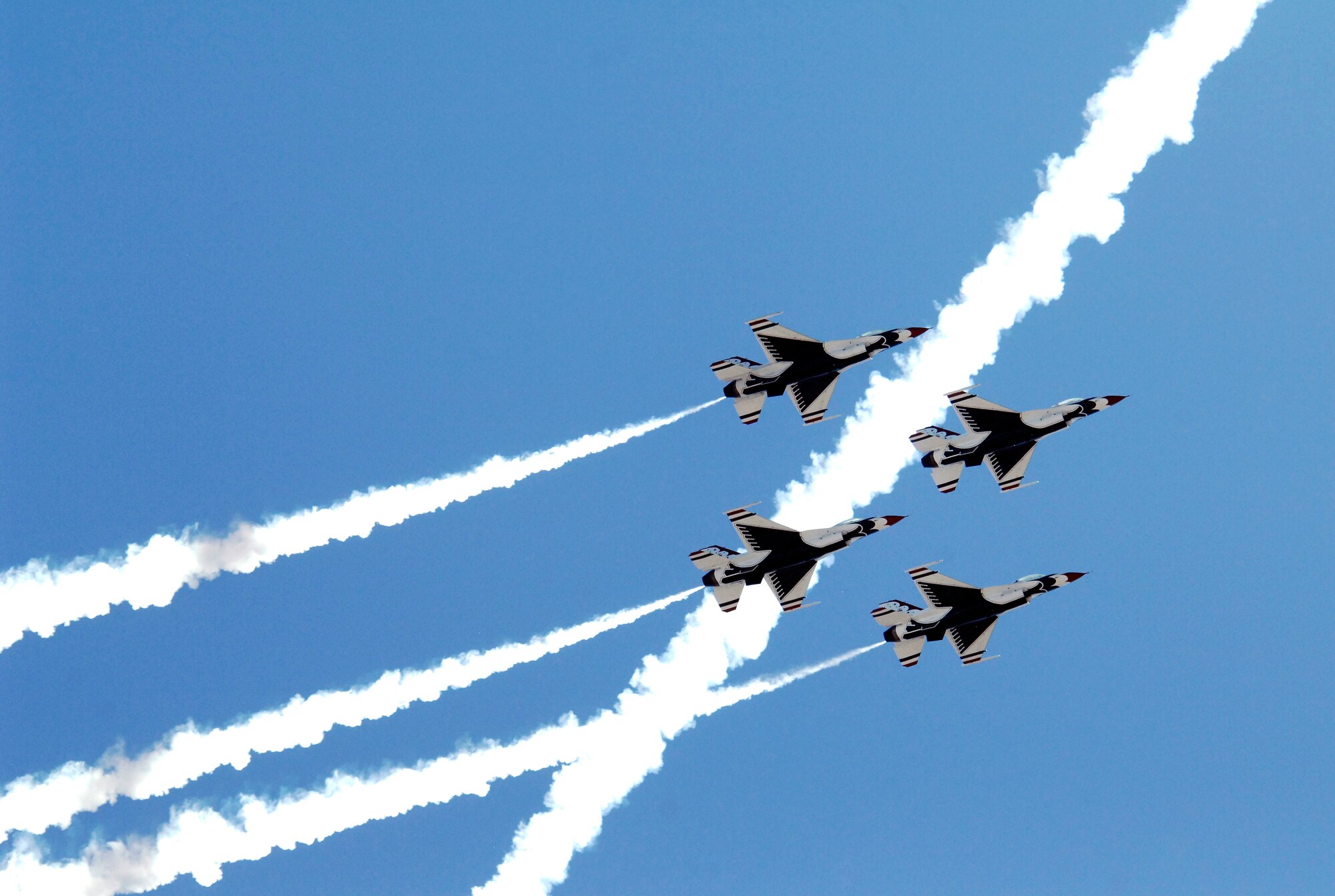 U.S. Air Force Thunderbirds Air Demonstration Squadron streams smoke across the sky while flying in a formation during the Thunder and Lightning over Arizona event at Davis-Monthan Air Force Base, Ariz., April 13, 2014. D-M held the event to show appreciation by opening its gates and allowing the general public to learn more about the U.S. Air Force while viewing aerial demonstrations. (U.S. Air Force Photo by Airman 1st Class Chris Massey/Released)