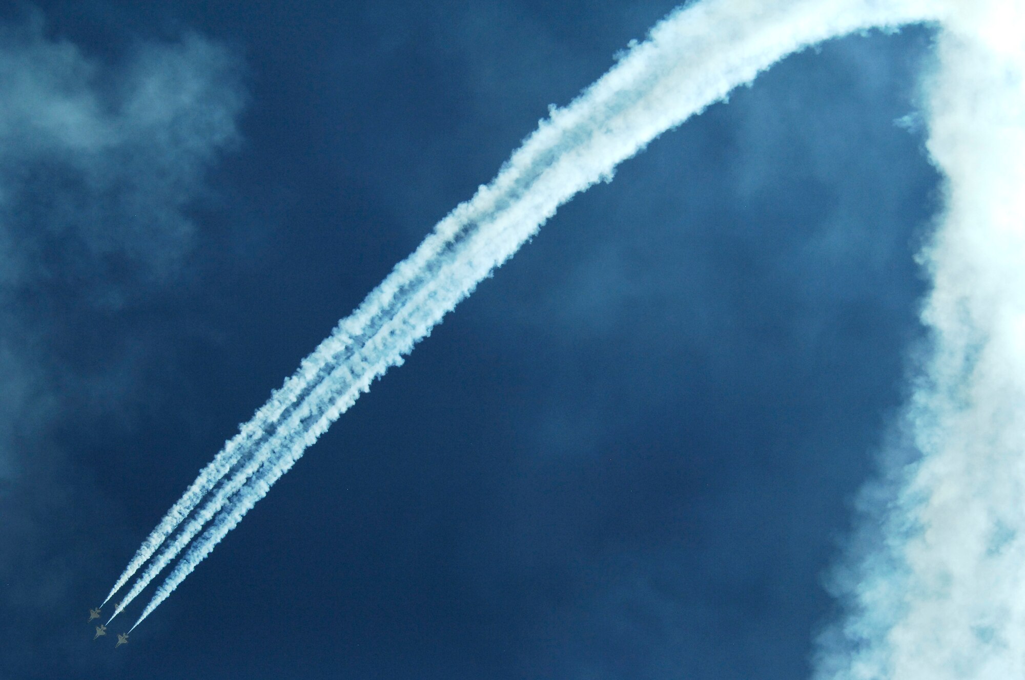 U.S. Air Force Thunderbirds Air Demonstration Squadron streams smoke across the sky while flying in a formation during the Thunder and Lightning over Arizona event at Davis-Monthan Air Force Base, Ariz., April 13, 2014. In addition to the Thunderbirds, there were 13 other aerial demonstrations including B-25 and P-51 flybys, a demo by the Air Force Academy Wings of Blue Parachute Team and a performance by the Desert Lighting Team. (U.S. Air Force Photo by Airman 1st Class Chris Massey/Released)