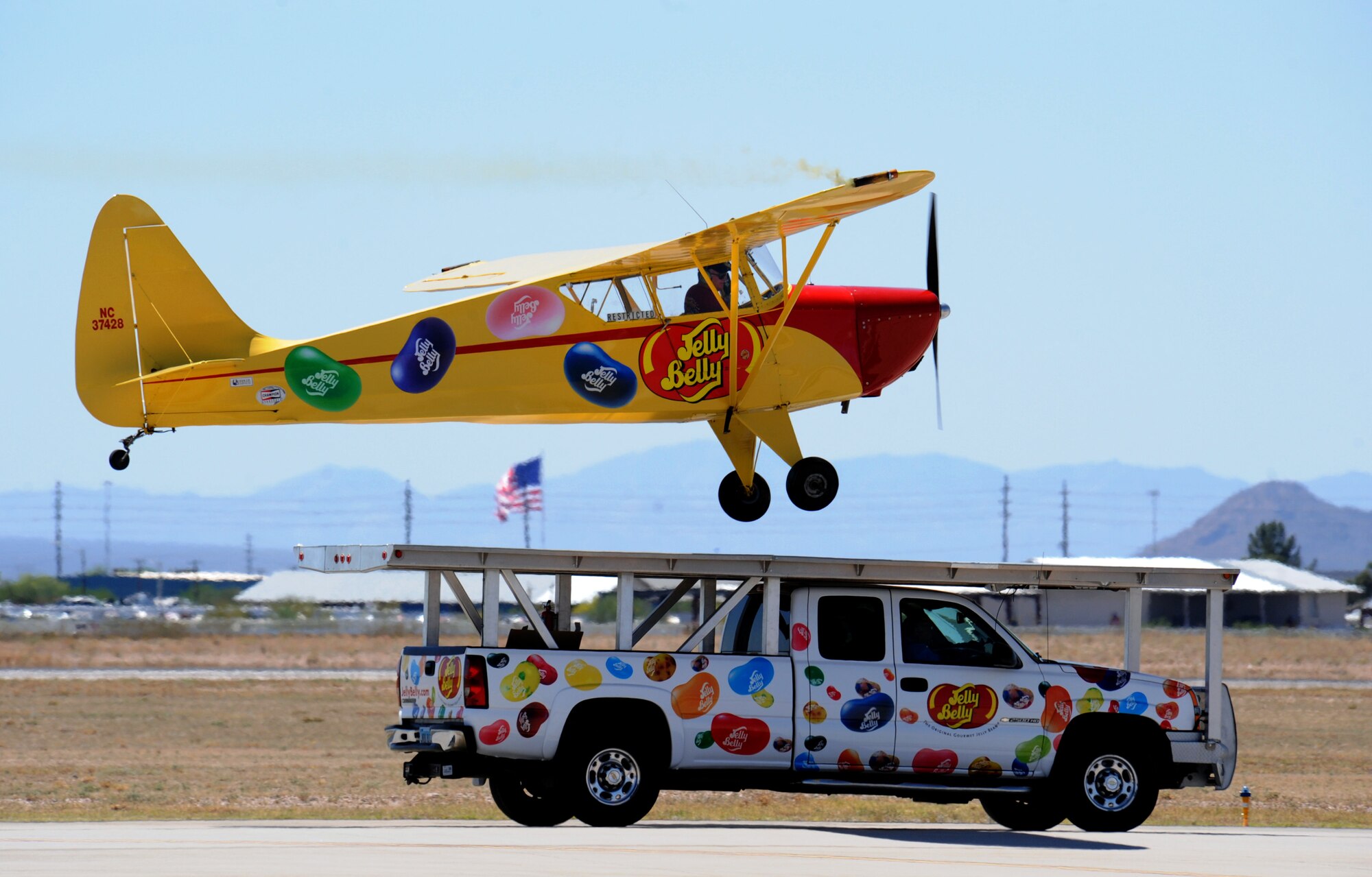 Kent Pietsch, pilot, attempts to land a plane on the truck counterpart during the Thunder and Lightning over Arizona event  at Davis-Monthan Air Force Base, Ariz., April 13, 2014. The plane is an 800-pound Interstate Cadet with a 37-foot wingspan. (U.S. Air Force Photo by Airman 1st Class Chris Massey/Released)