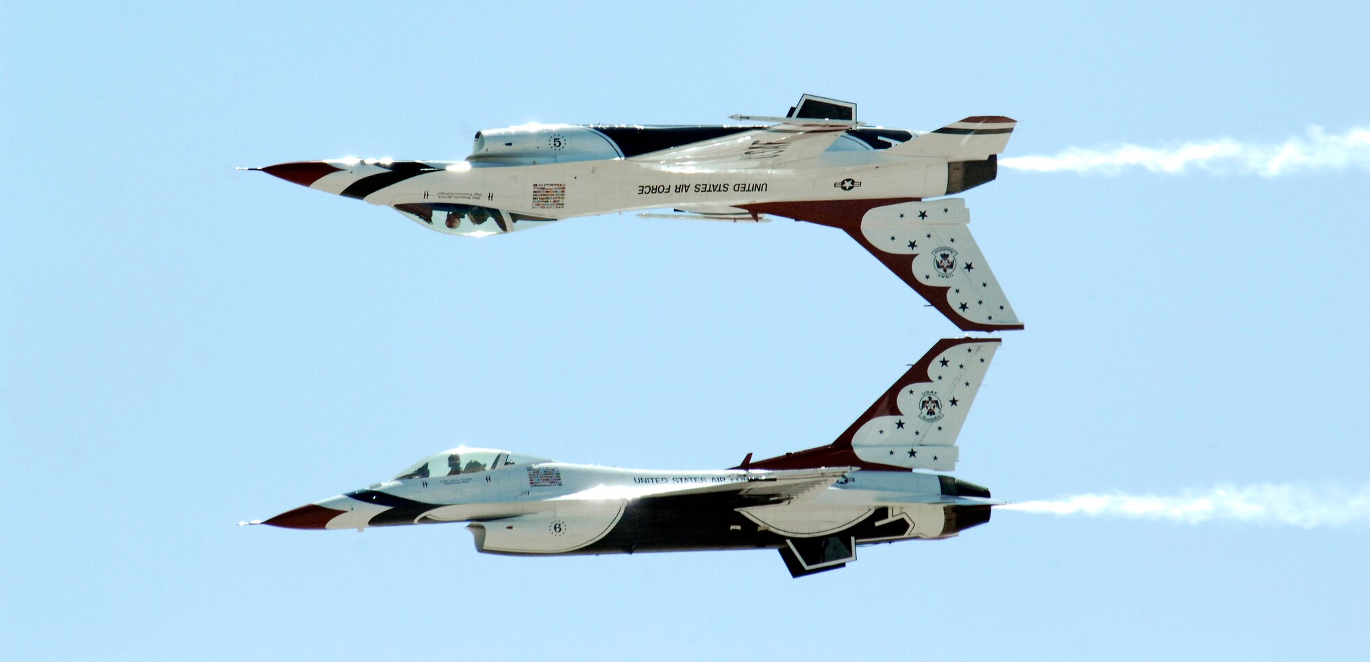 Two U.S. Air Force Thunderbirds perform an inverted formation fly-by during the Thunder and Lightning over Arizona event at Davis-Monthan Air Force Base, Ariz., April 13, 2014.  In addition to 14 aerial demonstrations, there were more than 40 aircraft static displays during the event.  (U.S. Air Force Photo by Airman 1st Class Chris Massey/Released)