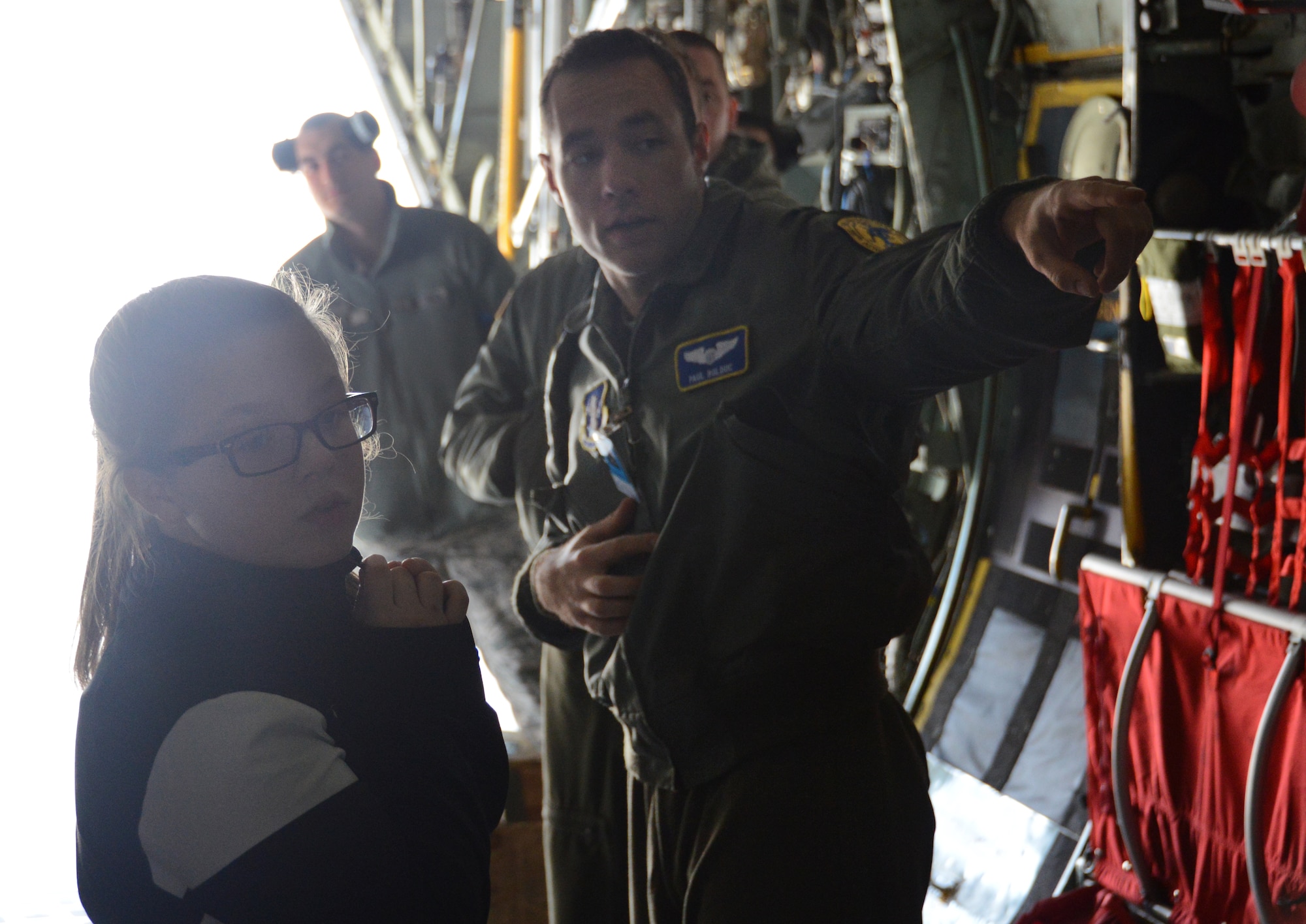 Looking down the belly of the C-130H, Tori Pilletere, 12, gets a fully immersive look and explanation of the capabilities of the aircraft by 1st Lt. Paul Bolduc, a pilot with the 118th Airlift Squadron, during a tour of the Bradley Air National Guard Base, East Granby, Conn., April 5,2014. The tour of the C-130H was part of the Connecticut Youth Council’s initiative to get more Air Guard youth involved with the council. (U.S. Air National Guard photo by Tech. Sgt. Joshua Mead)