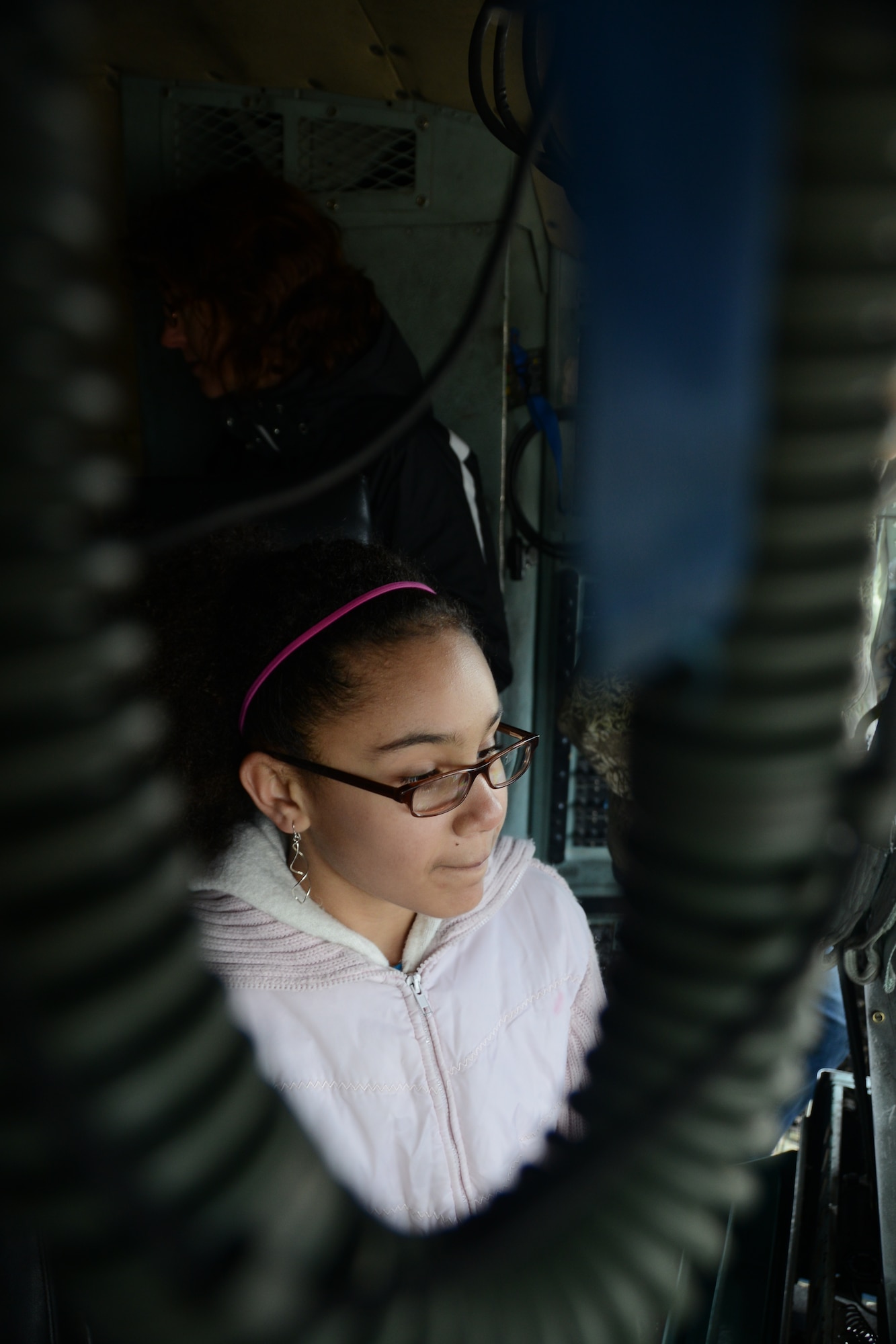 Sitting in the cockpit, Mia Jones, 12, daughter of Master Sgt. Peter Jones, First Sergeant with the 103rd Aircraft Maintenance Squadron, listens intently to 1st Lt. Paul Bolduc (not-pictured), a pilot from the 118th Airlift Squadron, as he explains what it takes to be a C-130H pilot during a tour of Bradley Air National Guard Base, East Granby, Conn., April 5, 2014. The tour was put on by the Connecticut National Guard Youth Council affording participants with a chance to sit at the controls of a C-130H, climb up into a crash and fire rescue truck assigned to the 103rd Civil Engineering Squadron’s fire house and a chance to witness a 103rd Security Forces training exercise up close. (U.S. Air National Guard photo by Tech. Sgt. Joshua Mead)  