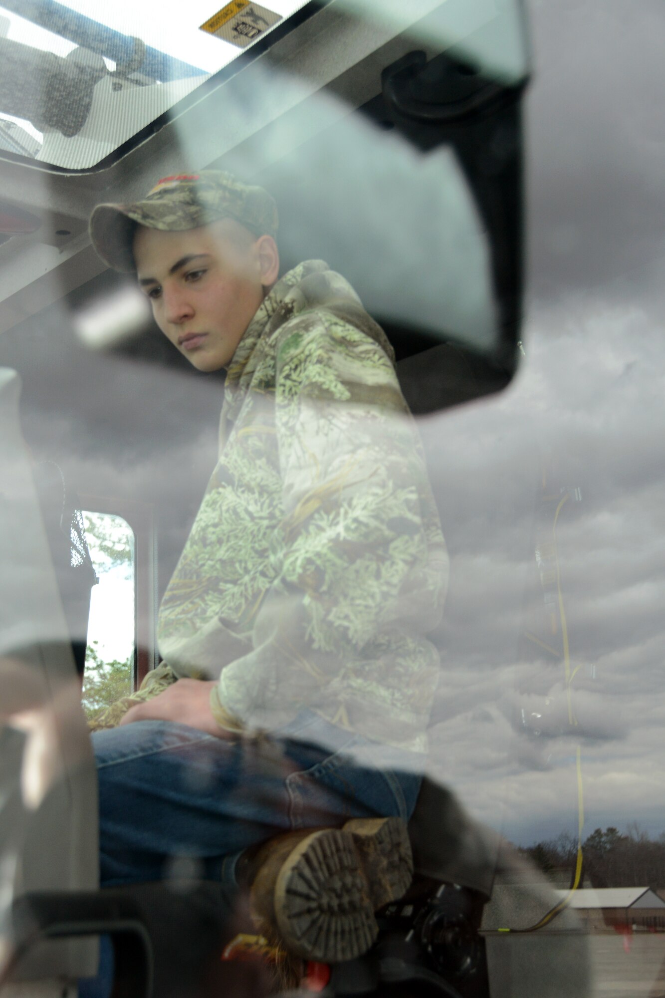 Cody Kirkland, 16, son of Master Sgt. Kirk Foran, 103rd Maintenance Group, inspects his surroundings as he sits inside the cab of a crash and fire rescue truck assigned to the 103rd Civil Engineering Squadron during the Connecticut Youth Council Program’s tour of Bradley Air National Guard Base, East Granby, Conn., April 5, 2014.  (U.S. Air National Guard photo by Tech. Sgt. Joshua Mead)