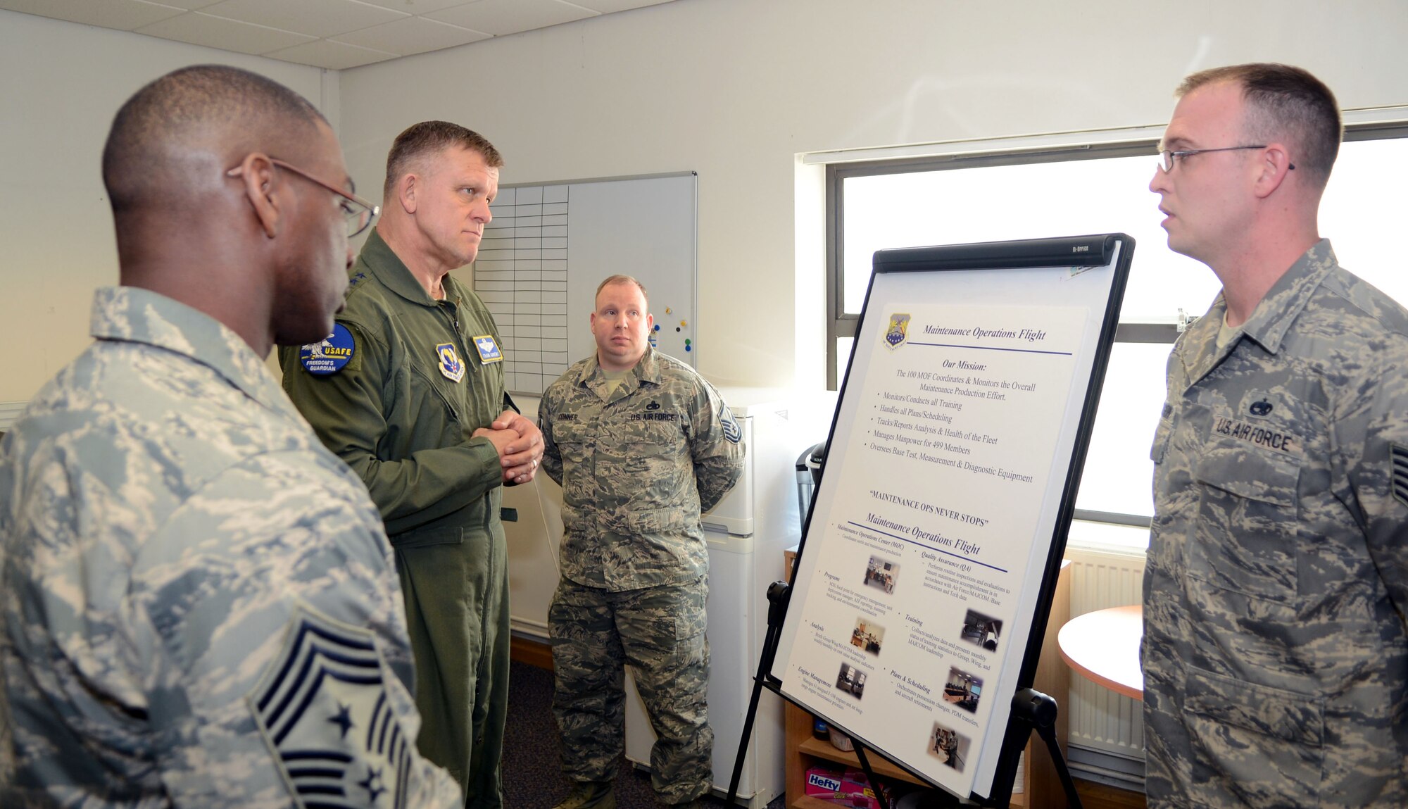 U.S. Air Force Gen. Frank Gorenc, U.S. Air Forces in Europe and Air Forces Africa commander, and Chief Master Sgt. James E. Davis, USAFE-AFAFRICA command chief, center, receive a mission briefing from a 100th Maintenance Operations Flight Airman April 14, 2014, at RAF Mildenhall, England. The commander’s day started out early at a breakfast with Airmen, after which he proceeded to visit several of the base’s key facilities. (U.S. Air Force photo by Airman 1st Class Jonathan Light/Released)