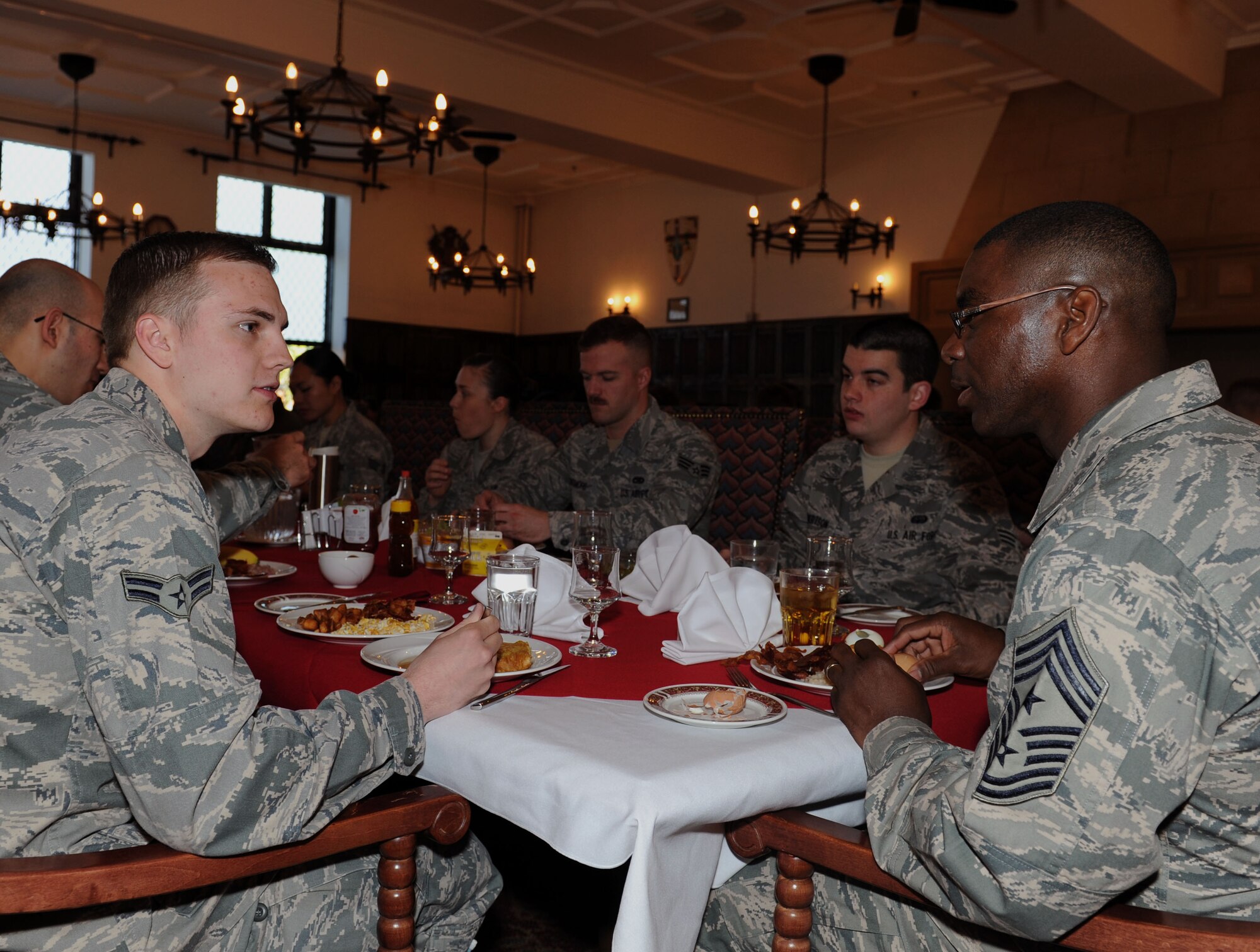 U.S. Air Force Chief Master Sgt. James E. Davis, right, U.S. Air Forces in Europe and Air Forces Africa command chief, speaks with U.S. Air Force Airman 1st Class William Fullmer, 100th Logistic Readiness Squadron Fuels Distribution fuels specialist from Provo, Utah, at an Airmen’s breakfast April 14, 2014, at the Gateway Dining Facility on RAF Mildenhall, England. Davis visited with Airmen to understand their perspective of the future on the Air Force. He also shared his thoughts on how they fit into the  command’s motto  of Forward, Ready, Now. (U.S. Air Force photo by Airman 1st Class Preston Webb/Released)