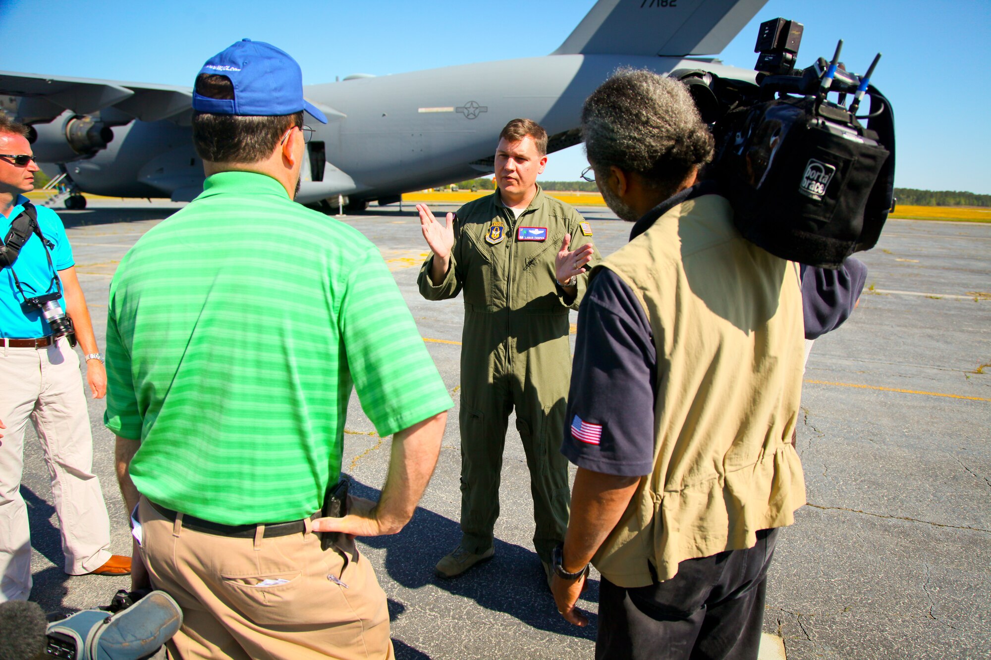 Lt. Col. Lamar Thigpen, the 315th Airlift Control Flight commander at Joint Base Charleston, S.C., talks to local media who came out to see the initial tank onload Thursday on the flight line at Wright Army Airflied, Ga. C-17's from JB Charleston, S.C., and Wright-Patterson Air Force Base, Ohio, transported four tanks from Wright AAF to McEntire Air National Guard Base, S.C., in support of a tank movement for the 1/118th CAB. (U.S. Air Force photo by Staff Sgt. Rashard Coaxum/released)
