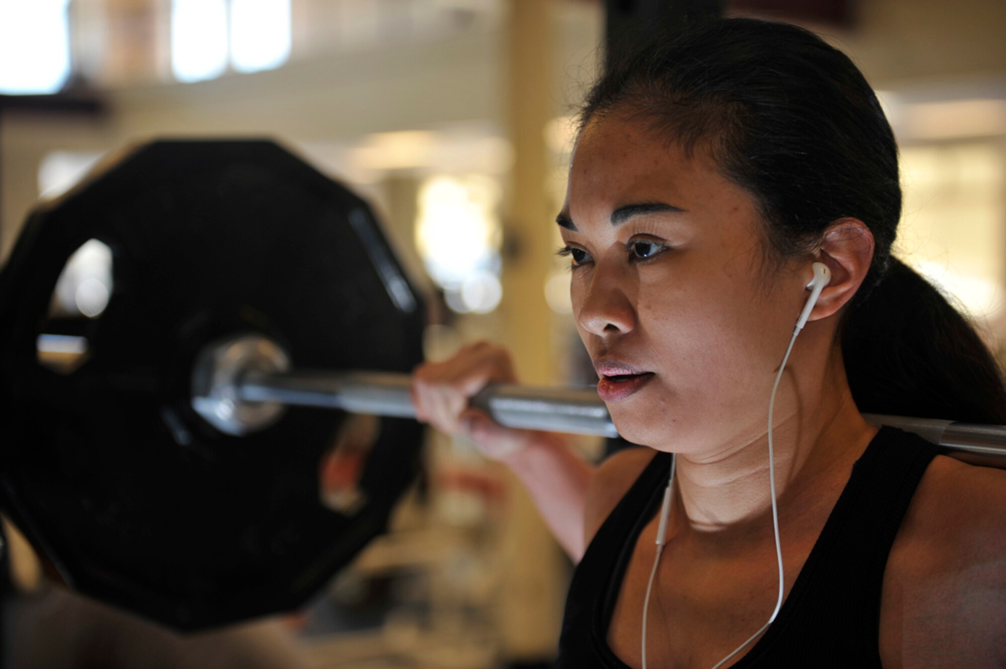 Carrie Ann Tissaw performs squats with 145 pounds at the JBER-E Fitness Center on Joint Base Elmendorf-Richardson, Alaska, April 9, 2014. Tissaw visits the fitness center to keep in shape for her job as a loss prevention associate at a local department store. Tissaw is the wife of Senior Airman Derek Tissaw, 773rd Logistics Readiness Squadron vehicle operator, and a native of Las Vegas. (U.S. Air Force photo/Airman 1st Class Tammie Ramsouer)