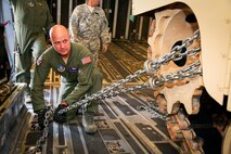 Tech. Sgt. John McNiece, a loadmaster with the 315th Airlift Control Flight at Joint Base Charleston, S.C., tightens up a chain device used to secure an M1A1SA Abrams main battle tank to the floor of a C-17 Globemaster III Friday at Wright Army Airfield, Ga. C-17's from JB Charleston, S.C., and Wright-Patterson Air Force Base, Ohio, transported four tanks from Wright AAF to McEntire Air National Guard Base, S.C., in support of a tank movement for the 1/118th CAB. (U.S. Air Force photo by Staff Sgt. Rashard Coaxum/released)
