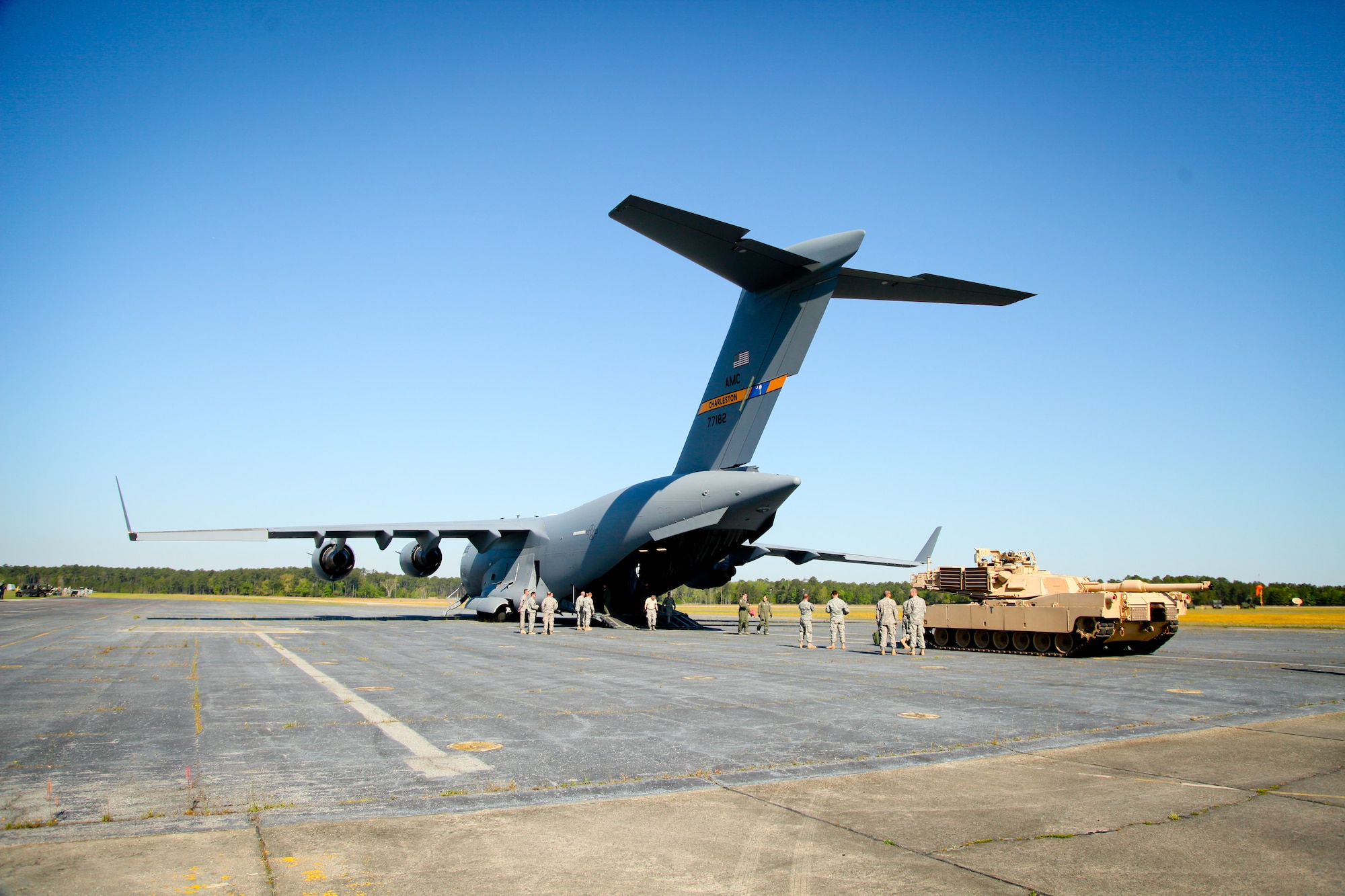 Joint Base Charleston, S.C., air and ground crews, along with a group of Army soldiers from the 1/118th Combat Arms Brigade, prepare to load an M1A1SA Abrams main battle tank onto a C-17 Globemaster III Thursday at Wright Army Airfield, Ga. C-17's transported four tanks from Wright AAF in support of a tank movement for the 1/118th CAB. (U.S. Air Force photo by Staff Sgt. Rashard Coaxum/released)