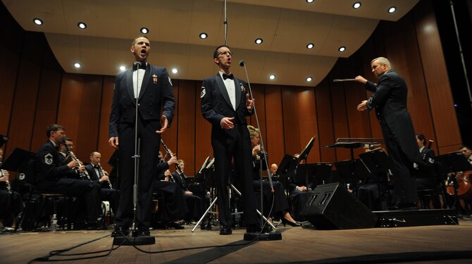 Col. Larry Lang conducts Tech. Sgt. Daniel Anderson and Master Sgt. Matthew Irish as they sing a duet during The U.S. Air Force Band Concert Band’s final performance during its 2014 Spring Tour at Michigan State University in East Lansing, Mich., April 13, 2014. Both Airmen are members of the Singing Sergeants, the official chorus of the U.S. Air Force. Anderson is a tenor vocalist and Irish is a baritone vocalist. Lang is the Band commander and conductor. (U.S. Air Force photo/Master Sgt. Tammie Moore)