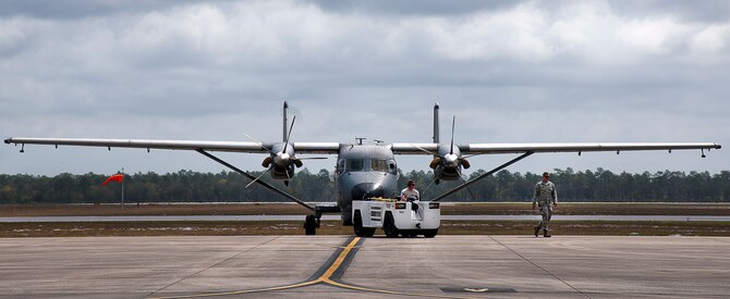A C-145 Skytruck is towed back to its parking area after routine maintenance at Duke Field, Fla. The Aviation Foreign Internal Defense and Skytruck mission is a joint active-duty and reserve Air Force Special Operations Command mission.  (U.S. Air Force photo/Tech. Sgt. Samuel King Jr.)
