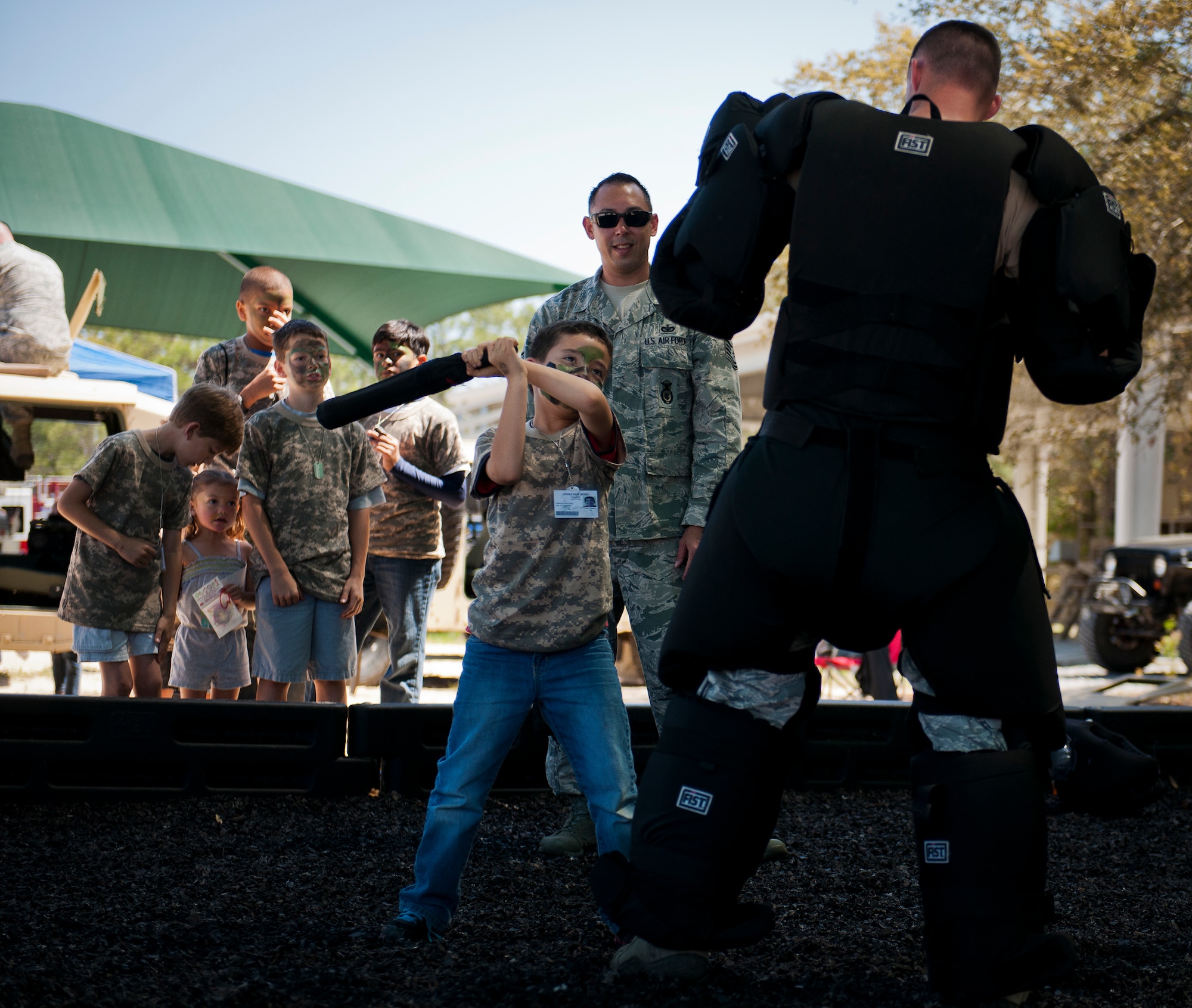 Little deployers got a chance to swat a bad guy during Operation Hero April 12 at Eglin Air Force Base, Fla.  Nearly 400 adults and children participated in the program this year, which served as a way to help children understand the military and the deployment process their parents have or could face.  The kids went through a deployment line to get their uniforms, dog tags and shots before they were briefed by their commander and shipped off to a deployed location.  There, they encountered military demonstrations, equipment and obstacle courses.  (U.S. Air Force photo/Samuel King Jr.)