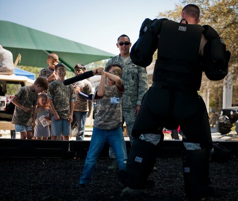 Little deployers got a chance to swat a bad guy during Operation Hero April 12 at Eglin Air Force Base, Fla.  Nearly 400 adults and children participated in the program this year, which served as a way to help children understand the military and the deployment process their parents have or could face.  The kids went through a deployment line to get their uniforms, dog tags and shots before they were briefed by their commander and shipped off to a deployed location.  There, they encountered military demonstrations, equipment and obstacle courses.  (U.S. Air Force photo/Samuel King Jr.)