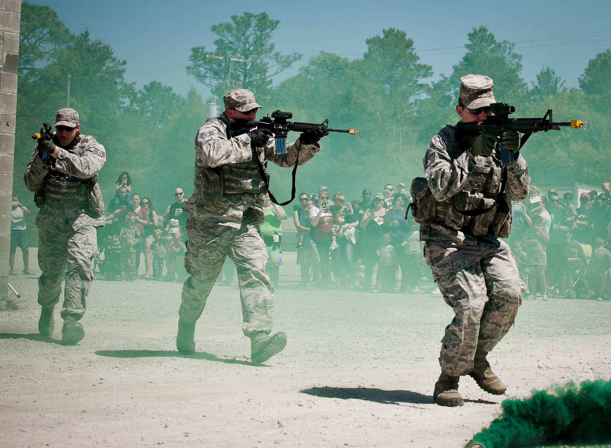 Airmen from the 96th Ground Combat Training Squadron perform a building-clearing demonstration during Operation Hero April 12 at Eglin Air Force Base, Fla.  Nearly 400 adults and children participated in the program this year, which served as a way to help children understand the military and the deployment process their parents have or could face.  The kids went through a deployment line to get their uniforms, dog tags and shots before they were briefed by their commander and shipped off to a deployed location.  There, they encountered military demonstrations, equipment and obstacle courses.  (U.S. Air Force photo/Samuel King Jr.)