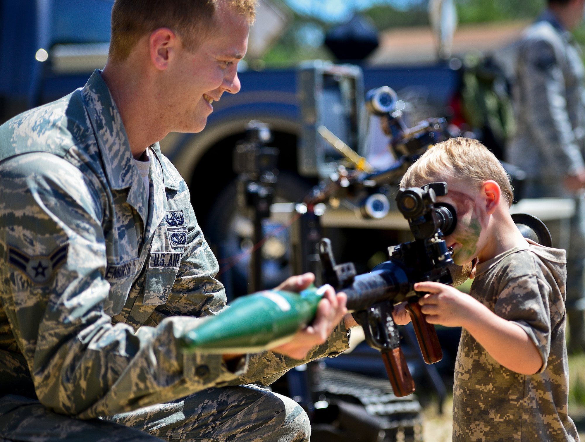 A little deployer tries out a rocket launcher during Operation Hero April 12 at Eglin Air Force Base, Fla.  Nearly 400 adults and children participated in the program this year, which served as a way to help children understand the military and the deployment process their parents have or could face.  The kids went through a deployment line to get their uniforms, dog tags and shots before they were briefed by their commander and shipped off to a deployed location.  There, they encountered military demonstrations, equipment and obstacle courses.  (U.S. Air Force photo/Samuel King Jr.)